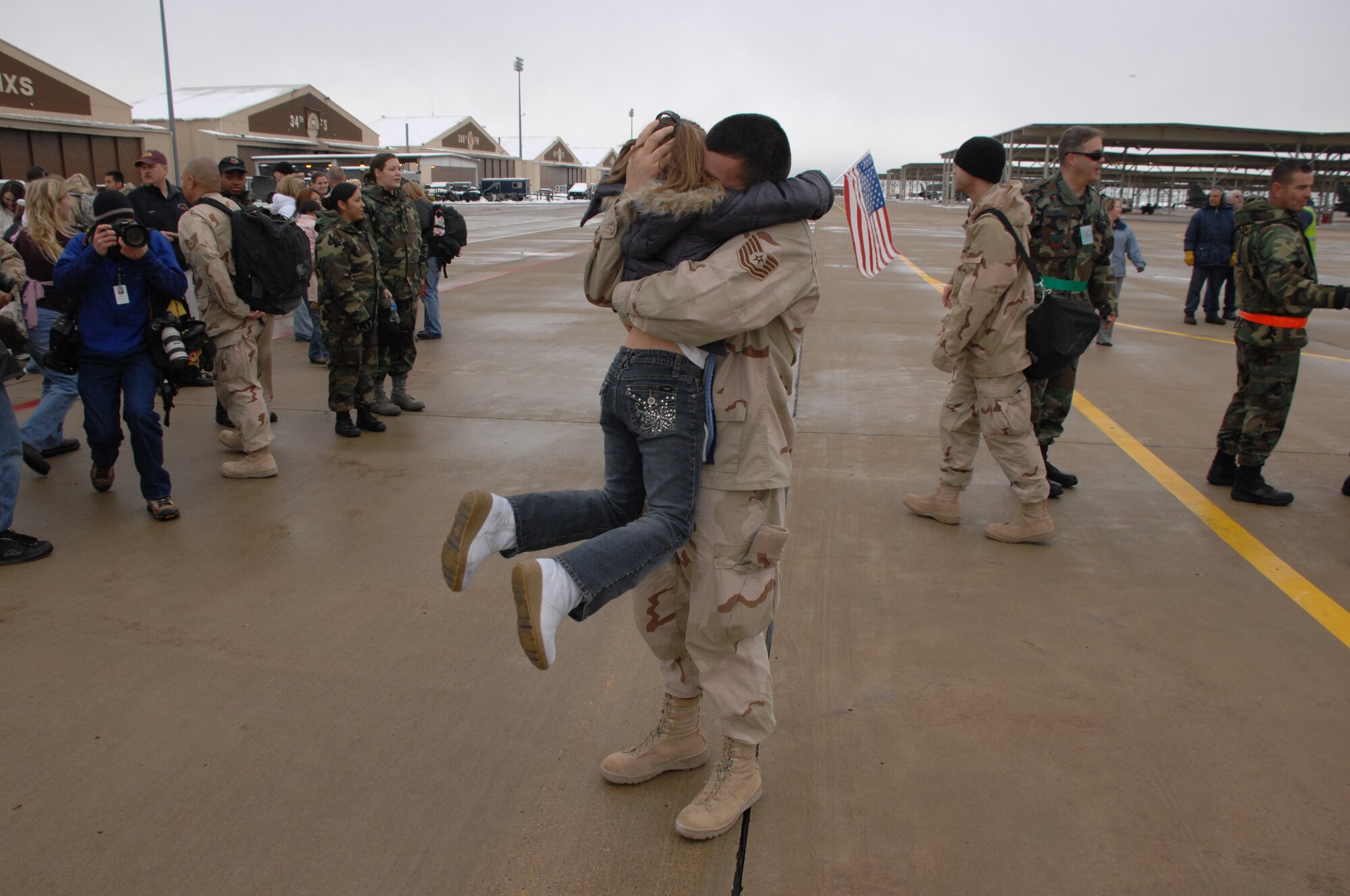 A 388th Fighter Wing Airman is greeted by a loved one at the 4th Fighter Squadron homecoming Jan. 8.  The wing's 4th Fighter Squadron deployed to Balad Air Base, Iraq in August and flew approximately 1,800 missions in support of ground forces in Operation Iraqi Freedom.  (U.S. Air Force photo by Alex Lloyd)