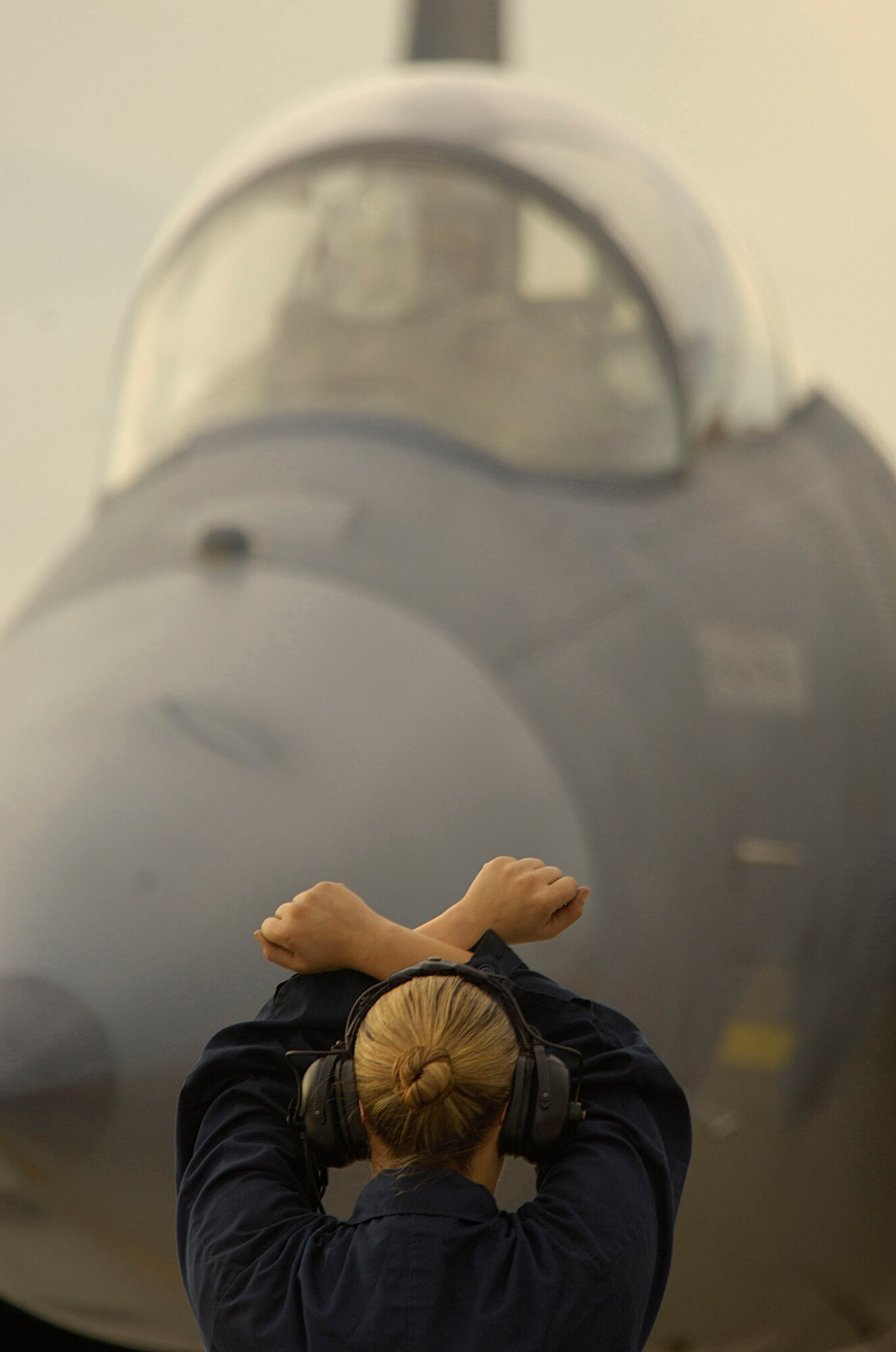 LANGLEY AIR FORCE BASE, Va. -- Staff Sgt. Elizabeth Harding, an F-15 dedicated crew chief with the 71st Aircraft Maintenance Unit, waits for a signal from Capt. Glenn Gonzales that he is ready to taxi his F-15 Eagle Jan. 9. After a month-long stand-down, the 71st Fighter Squadron launched the first of its F-15C fleet Jan. 9 at 9:30 a.m. (U.S. Air Force photo/Staff Sgt. Samuel Rogers)