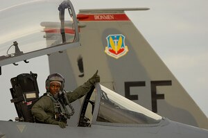 LANGLEY AIR FORCE BASE, Va. -- Capt. Glenn Gonzales, an F-15 Eagle pilot with the 71st Fighter Squadron, checks to see if his wingman, Lt. Col. Robert Garland, 71st FS commander, is ready the start engines Jan. 9. After a month-long stand-down, the 71st launched the first of their F-15C fleet Jan. 9 at 9:30 a.m. (U.S. Air Force photo/Staff Sgt. Samuel Rogers)
