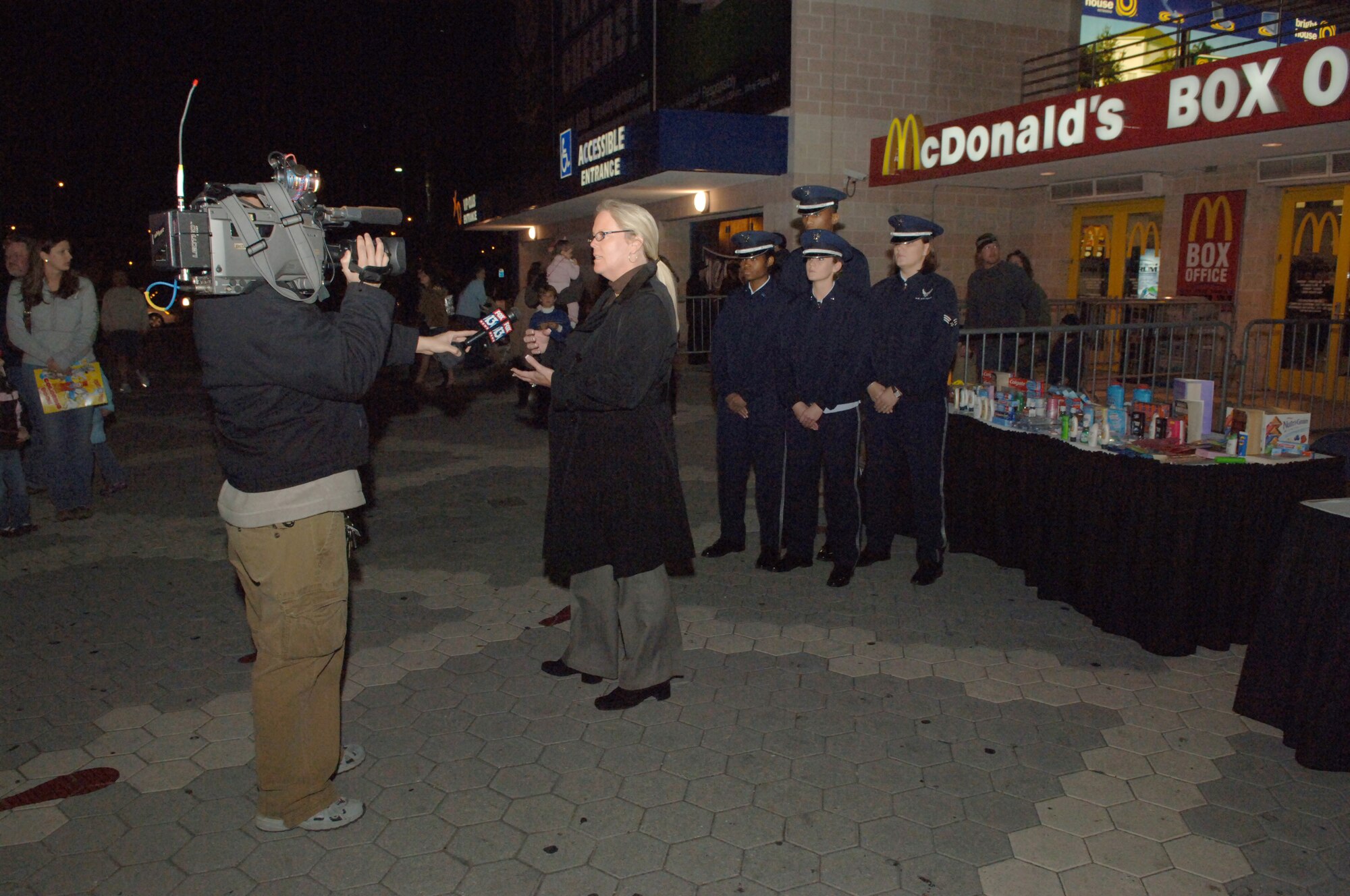 Melinda Hartline, Regional Public Relations Manager for Feld Entertainment gives a interview with the MacDill AFB Honor Guard in the back ground before the start of the Ringling Bros. and Barnum & Bailey Circus at the St. Pete Times Forum in Tampa, Fla, Jan. 4.  (U.S. Air Force photo by Staff Sgt. Joseph Swafford, Jr.)(Released)