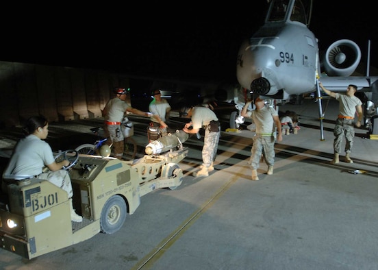 A 438th Air Expeditionary Group weapons loading team prepares to mount a Joint Direct Attack Munition to an A-10C Thunderbolt II using an MJ-1 “jammer” vehicle here. The Airmen made history in Iraq when their upgraded A-10s successfully employed JDAMs in combat. Because the weapon is guided to targets by pinpoint GPS coordinates, experts here say it is 100 percent more accurate than munitions previously employed on the A-10C Thunderbolt II, dramatically improving precision and reducing fratricide. The Airmen are deployed from the 175th Wing, Maryland Air National Guard, located in Baltimore, Md. (U.S. Air Force photo/Tech. Sgt. D. Clare)