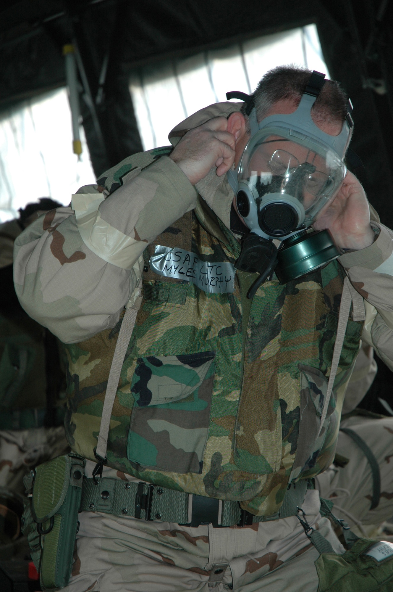 Lt. Col. Myles Murphy, 512th Mission Support Group deputy commander, dons his gas mask Jan. 5 during the Haunted House Battle Ax.  512th Airlift Wing Airmen were tested on their ability to survive and operate in a combat environment. (U.S. Air Force photo/Senior Airman Andria Allmond)
