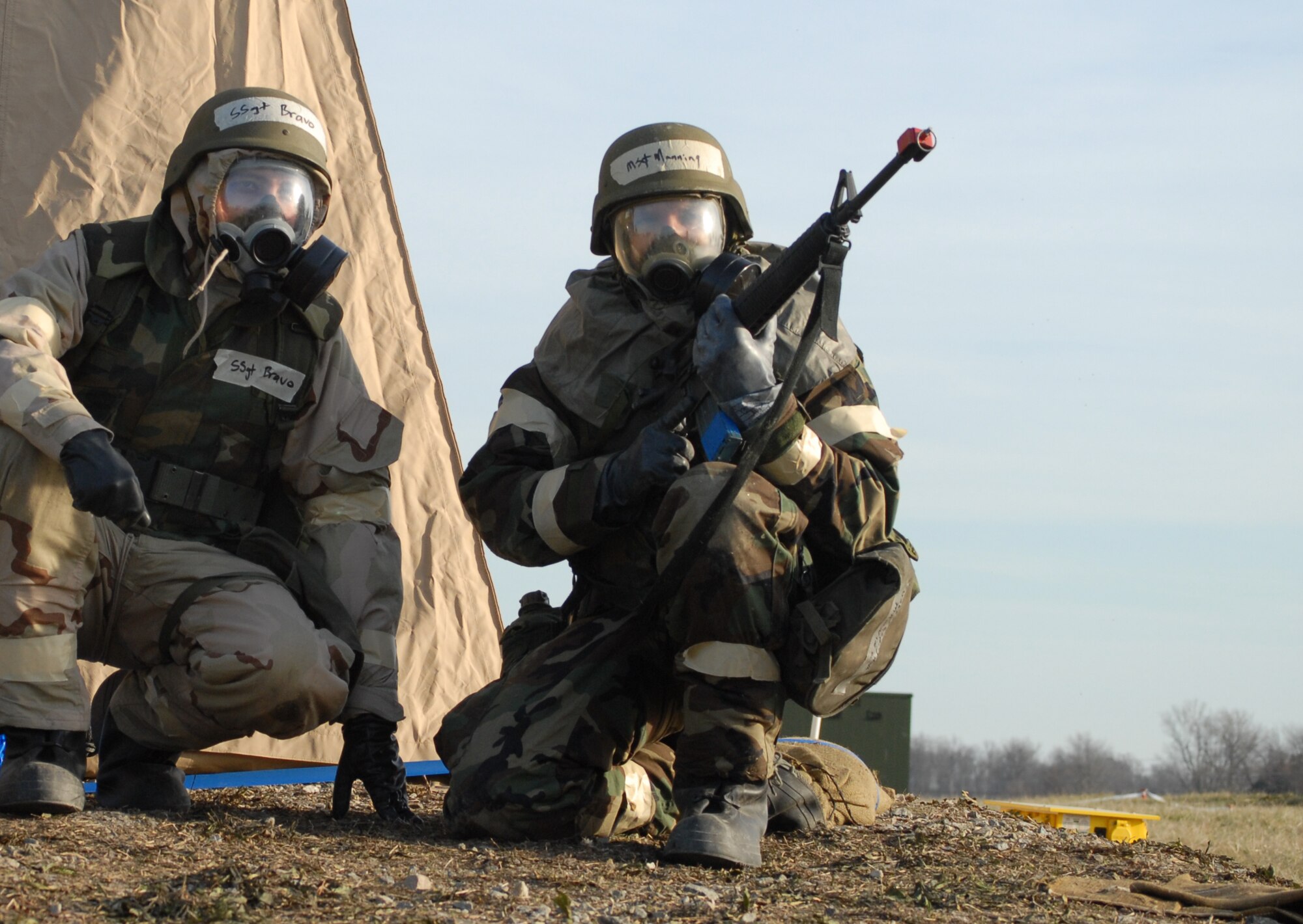 Master Sgt. Hugh Manning, 436th Aerial Port Squadron, and Staff Sgt. Michael Bravo, 436th APS, perform door-guard duties and protect their tent during Dover Air Force Base's Haunted House Battle Axe exercise Jan. 7. Defensive measures was one of the many skills practiced during the exercise. (U.S. Air Force photo/Tech. Sgt. Kevin Wallace)