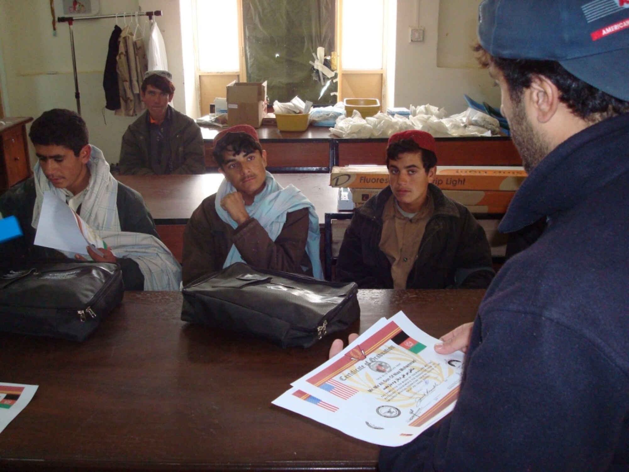 Students of a basic Emergency Medical Technician training course here listen to their instructor during a graduation ceremony Jan. 8.  The three-month EMT course—which is facilitated by Provincial Reconstruction Team Qalat—is similar to a basic first aid class or the military’s self-aid and buddy care training.  (Air Force photo by Capt. Bob Everdeen)