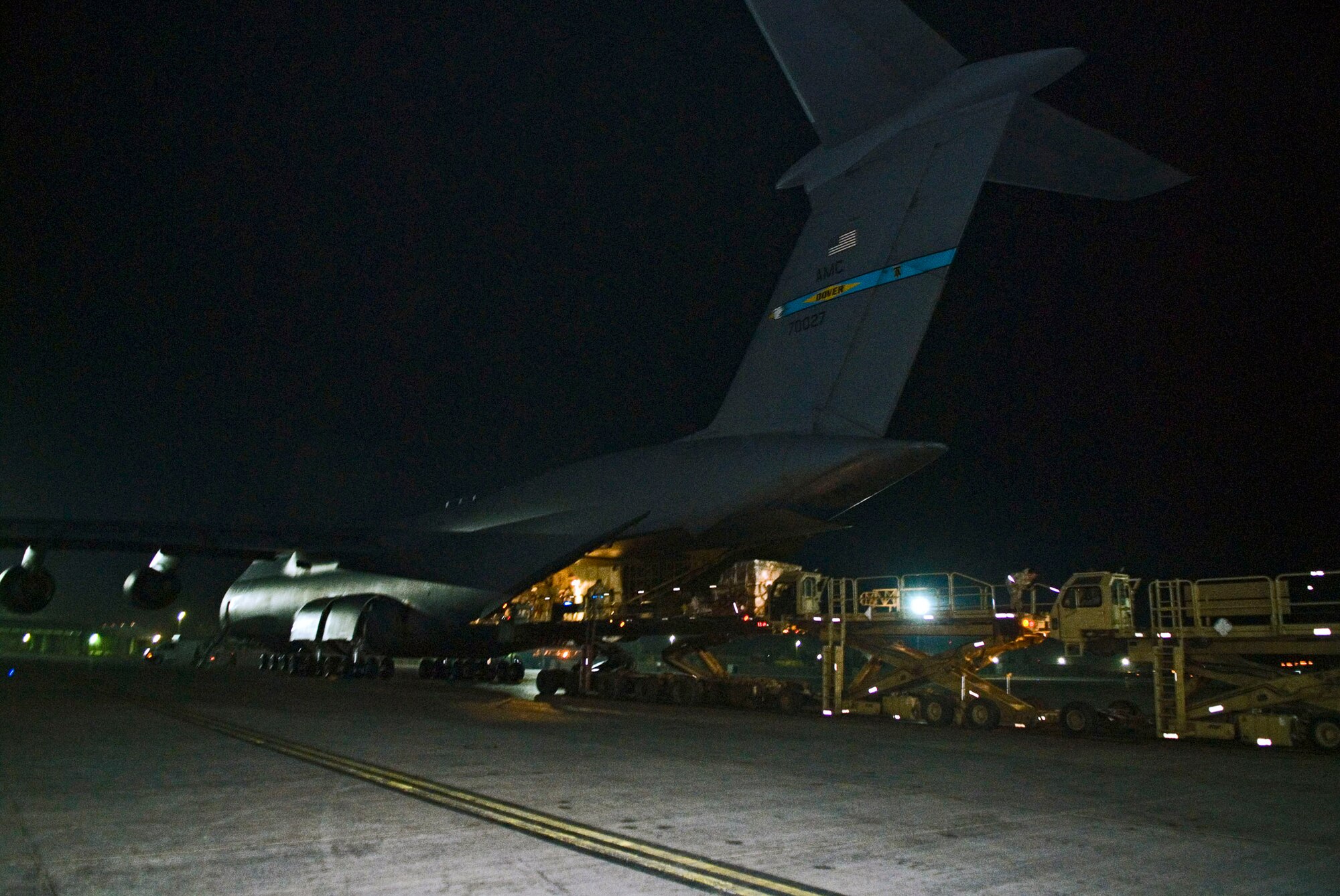 A C-5 Galaxy is downloaded Jan. 7 at Balad Air Base, Iraq. The C-5 can hold a cargo load of 270,000 pounds, fly 2,150 nautical miles, offload, and fly to a second base 500 nautical miles away from the original destination without refueling. (U.S. Air Force photo/Staff Sgt. Joshua Garcia) 
