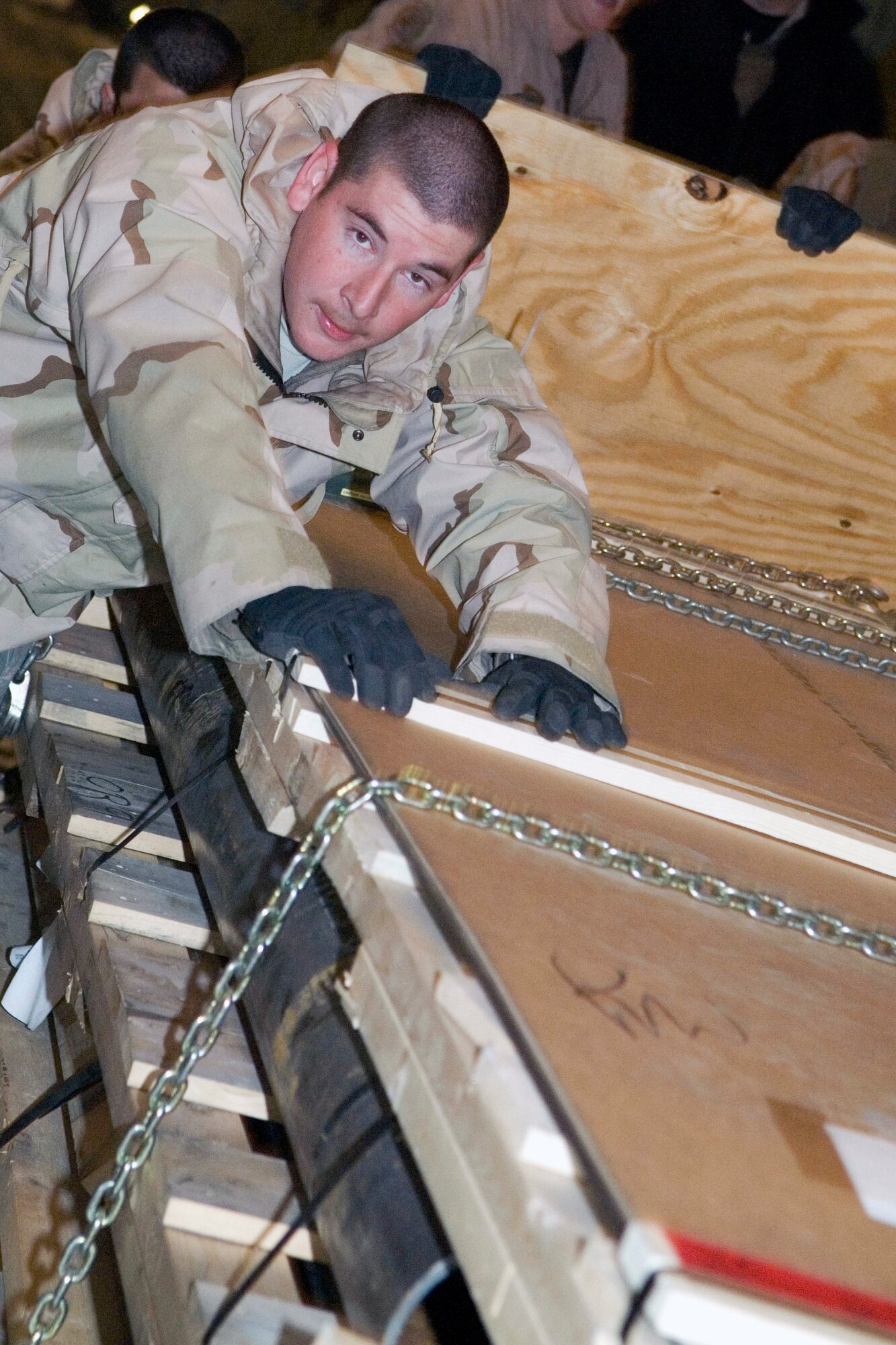 Airman 1st Class Terrence West pushes cargo from a C-5 Galaxy Jan. 7 at Balad Air Base, Iraq. Balad AB has the busiest aerial port in the area of responsibility and the air transportation specialists here recently bested their previous record by moving 930 tons of cargo in one day. Airman West, a 332nd Expeditionary Logistics Readiness Squadron air transportation specialist, is deployed from Altus Air Force Base, Okla. (U.S. Air Force photo/Staff Sgt. Joshua Garcia) 
