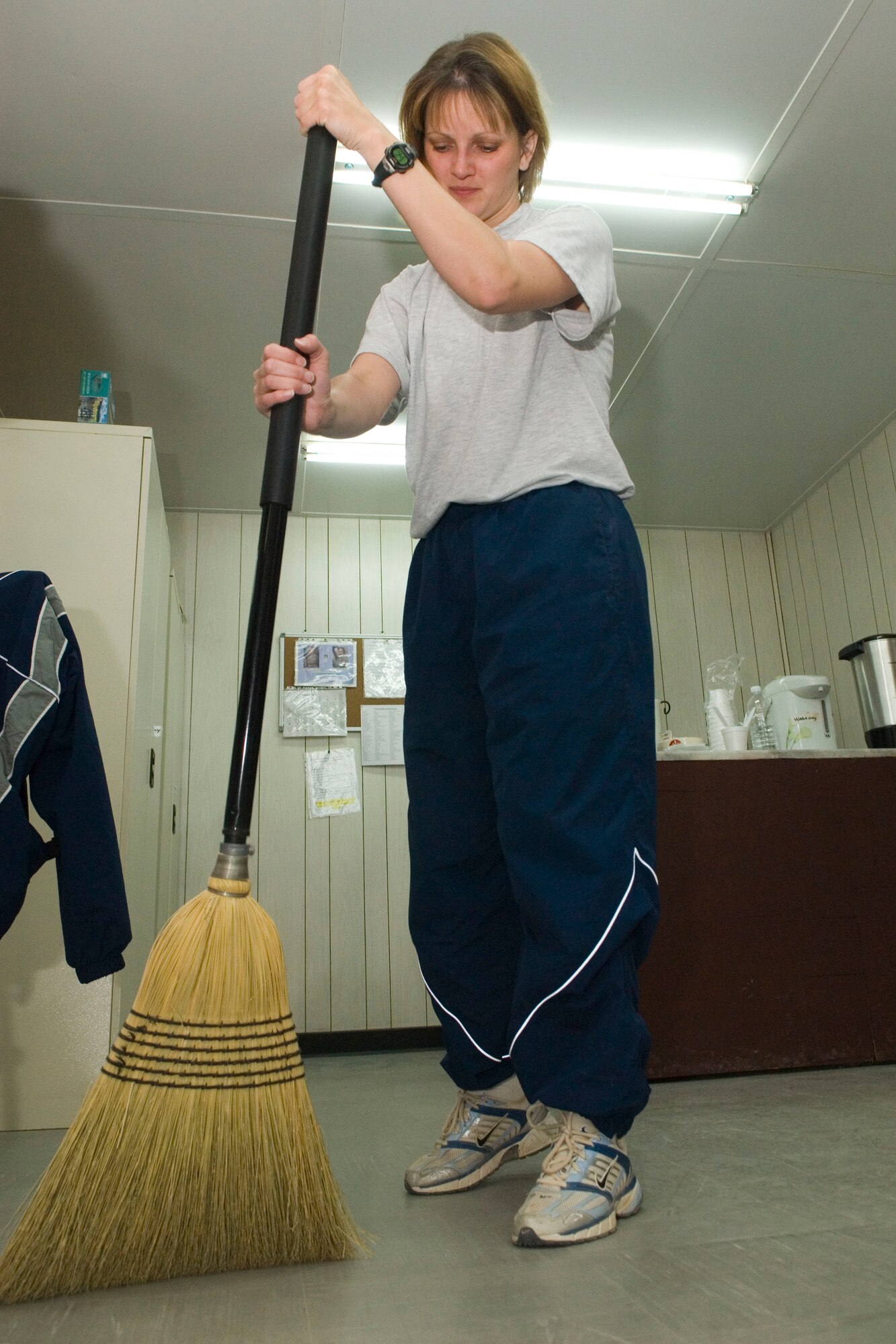 BALAD AIR BASE, Iraq -- Staff Sgt. Julie Boyatt, 332nd Expeditionary Operations Support Squadron, sweeps the floor at "Troy's Place," as part of her volunteer duties. Volunteers ensure the recreational sanctuary is kept clean and fully stocked. Sergeant Boyatt has logged more than 100 hours volunteering during her deployment. Sergeant Boyatt is deployed from Peterson Air Force Base, Colo.  (U.S. Air Force photo/Staff Sgt. Joshua Garcia) 