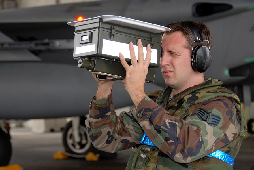 Staff Sgt. Daniel Connolly, 18th Aircraft Maintenance Squadron, looks through a Mode IV/IFF Tester in a pre-flight check of an F-15C during Local Operational Readiness Exercise Beverly High 08-3 at Kadena Air Base, Japan, Jan. 9, 2007. The 18th Wing exercise from Jan. 7 to 11 tests the wing's ability to respond in contingency situations.   (U.S. Air Force photo/Tech. Sgt. Anthony Iusi)