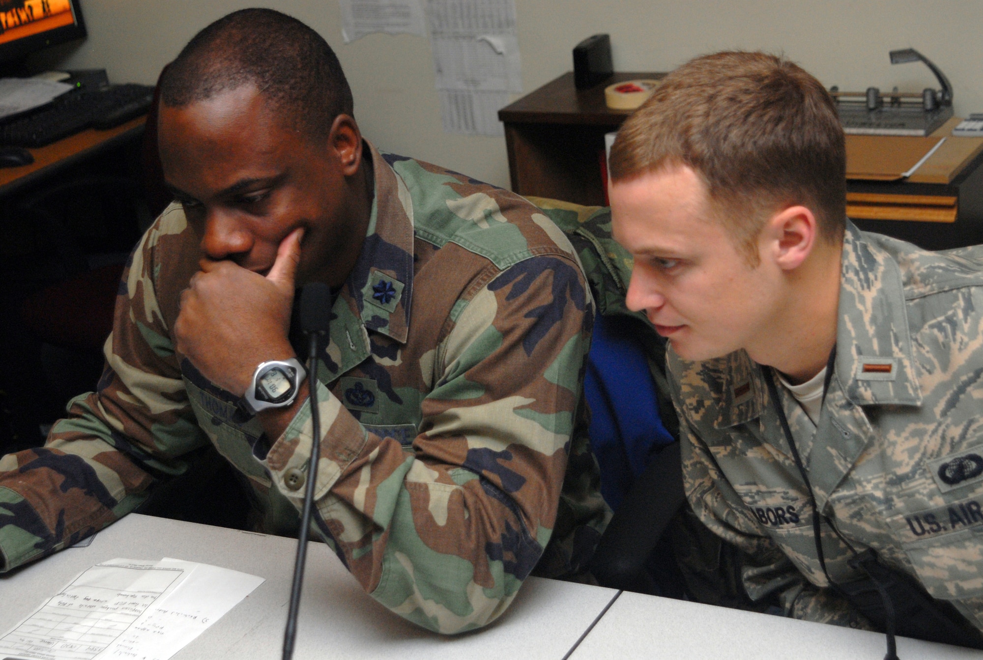 Lt. Col. Dwayne Thomas, the Emergency Operations Center manager and 2nd Lt. Joshua Nabors, 18th Contracting Squadron, reviews wing information inside the EOC during Local Operational Readiness Exercise Beverly High 08-3 at Kadena Air Base, Japan, Jan. 7, 2007. The 18th Wing exercise from Jan. 7 to 11 tests the wing's ability to respond in contingency situations. (U.S. Air Force photo/Staff Sgt. Christopher Marasky)