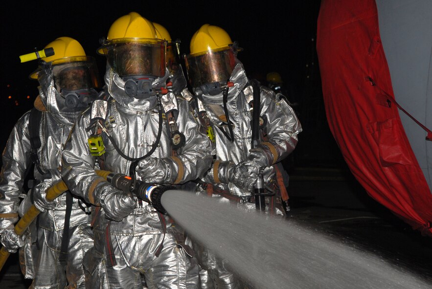 Firefighters assigned to the 18th Civil Engineer Squadron, work together to hose down a simulated fire from an attack scenario, during Local Operational Readiness Exercise Beverly High 08-3 at Kadena Air Base, Japan, Jan. 9, 2007. The 18th Wing conducted the exercise from Jan. 7 to 11 to test Airmen's ability to respond in contingency situations. (U.S. Air Force photo/Staff Sgt Chrissy FitzGerald)