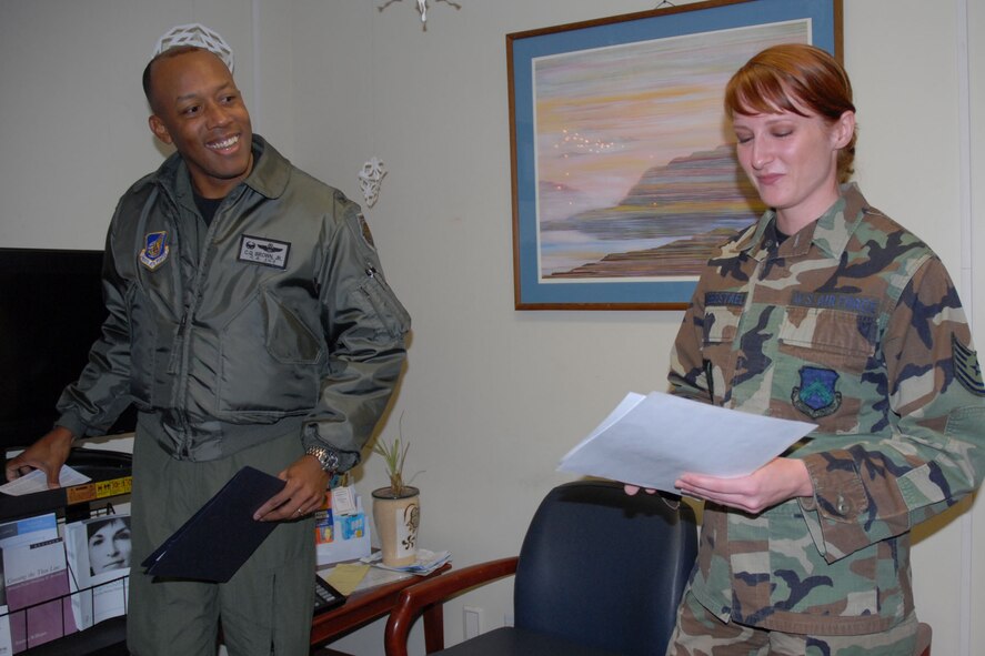 KUNSAN AIR BASE, South Korea -- Colonel CQ "Wolf" Brown, 8th Fighter Wing commander, congratulates Tech. Sgt. Catherine Lobbestael, 8th Medical Operations Squadron, NCO in charge of psychology here Jan. 9. Sergeant Lobbestael was selected as the 8th Fighter Wing's Pride of the Pack for the week of Jan. 10. (U.S. Air Force photo/Staff Sgt. Araceli Alarcon)   