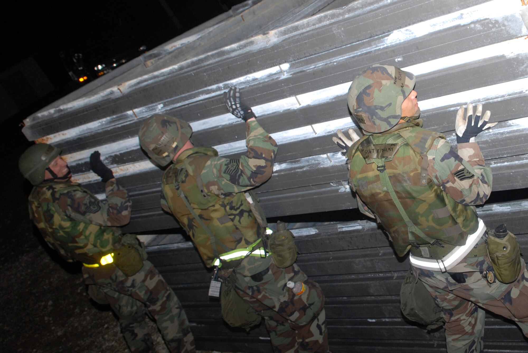 Airmen assigned to the 18th Civil Engineer Squadron, adjust revetment walls so that they can be secured by locking pins during a Local Operational Readiness Exercise Beverly High 08-3 scenario at Kadena Air Base, Japan, Jan. 8, 2007. The 18th Wing conducted the exercise from Jan. 7 to 11 to test Airmen's ability to respond in contingency situations. (U.S. Air Force photo/Staff Sgt Chrissy FitzGerald)
