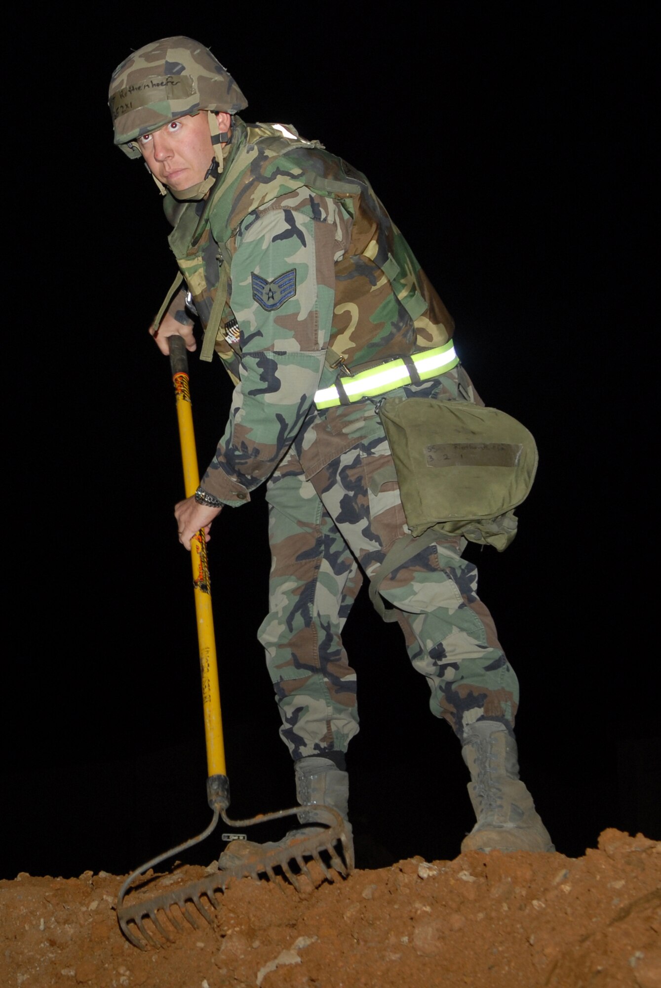 Staff Sgt. Daniel Rothenhoefer, 18th Civil Engineer Squadron, levels the top of a 10,000 gallon fuel berm during a Local Operational Readiness Exercise Beverly High 08-3 at Kadena Air Base, Japan, Jan. 8, 2007. The 18th Wing conducted the exercise from Jan. 7 to 11 to test Airmen's ability to respond in contingency situations. (U.S. Air Force photo/Staff Sgt Chrissy FitzGerald)