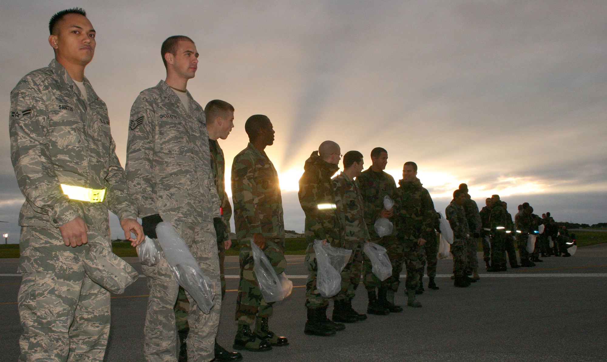 About 500 servicemembers get on line to search for debris on the two runways at Kadena Air Base, Japan, during the annual FOD Walk Jan. 3, 2007. More than 500 others cleaned their units' maintenance areas and parking lots at the same time. (Stars and Stripes photo/Cindy Fisher) 