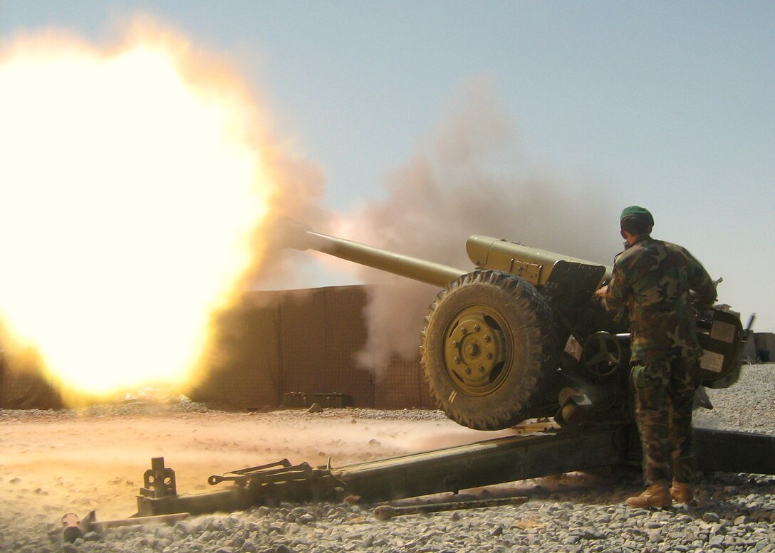 An artilleryman from the Afghan National Army's 205th Corps fires a round from a D-30 artillery piece during an indirect-fire support mission in Qalat, Afghanistan. The D-30 is part of a three-gun battery at Forward Operating Base Wolverine in Zabul province. Photo by Sgt. 1st Class David Trice, USA 