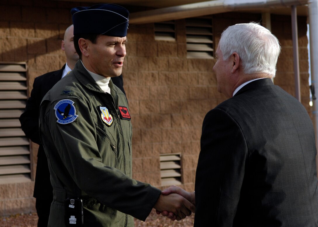 Air Force Col. Christopher Chambliss, commander of the 432nd Wing, greets Defense Secretary Robert M. Gates upon his arrival at Creech Air Force Base, Nev., Jan. 8, 2008. 