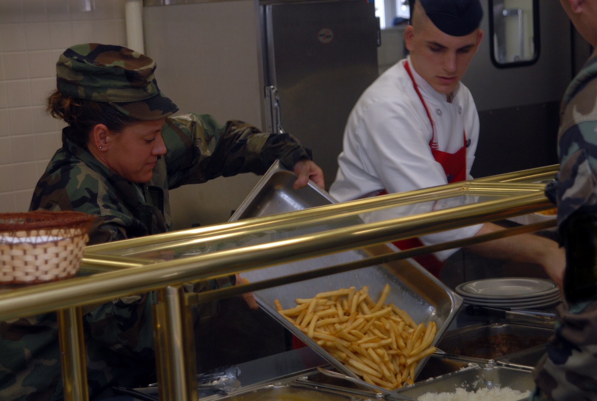 Tech. Sgt. Tina Todaro fills the delivers fresh new fries to the serving line within the Johnson dining facility during Local Operational Readiness Exercise Beverly High 08-3 at Kadena Air Base, Japan, Jan. 11, 2007. The 18th Wing exercise from Jan. 7 to 11 tests the wing's ability to respond in contingency situations. (U.S. Air Force photo/Staff Sgt. Christopher Marasky)
