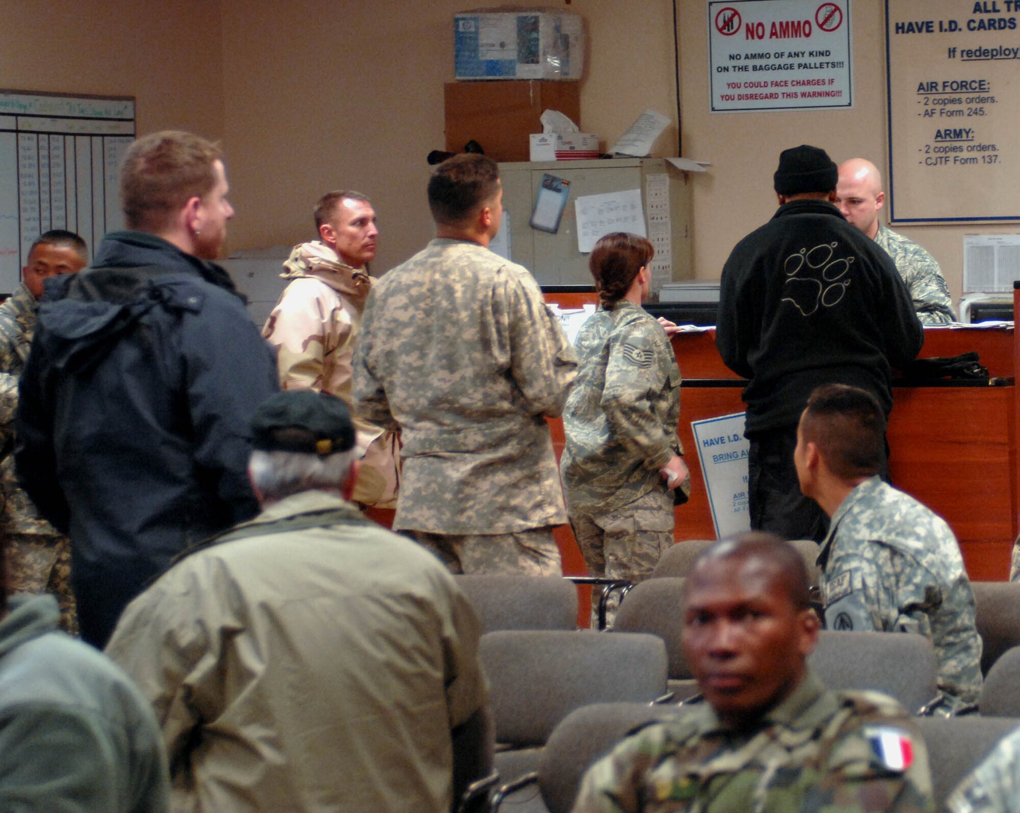 BAGRAM AIR BASE, Afghanistan -- Travelers wait in line during roll call at the passenger terminal here. Airmen in the passenger terminal typically process more than 650 travelers each month. (U.S. Air Force photo by Staff Sgt Mike Andriacco) 