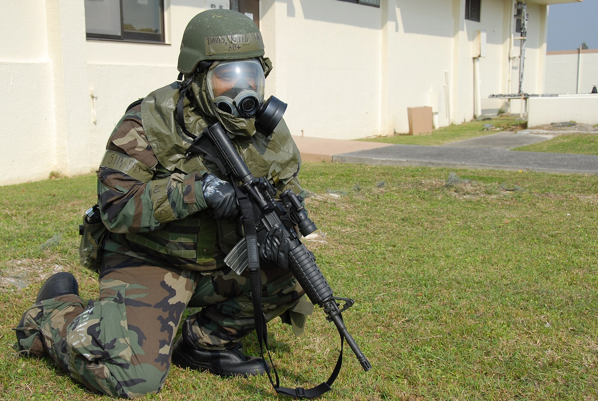 Senior Airman Peter Davis, 18th Security Forces Squadron, secures the 18th Wing Command Post building following a simulated missile attack during Local Operational Readiness Exercise Beverly High 08-3 at Kadena Air Base, Japan, Jan. 10, 2007. The 18th Wing conducted the exercise from Jan. 7 to 11 to test the wing's ability to respond in contingency situations. (U.S. Air Force photo/Tech Sgt. Anthony Iusi) 