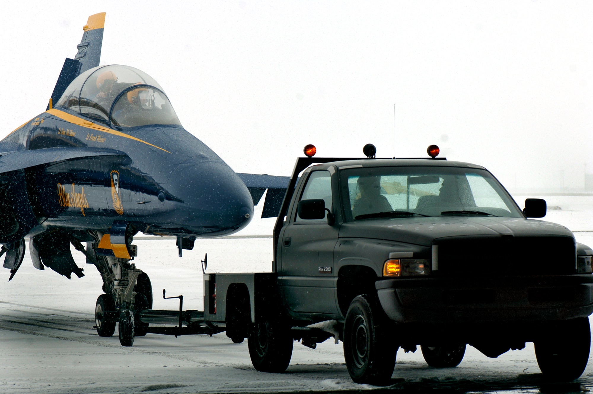 FAIRCHILD AIR FORCE BASE, Wash. – Fairchild Airmen from the 92nd Logistics Readiness Squadron tow a Blue Angels F/A-18 into a hangar on Jan 8. The Blue Angels member visited Fairchild to help plan and coordinate details for the airshow, Skyfest 2008, scheduled for Aug. 8-10.  (U.S. Air Force photo / Airman 1st Class Joshua Chapman) 