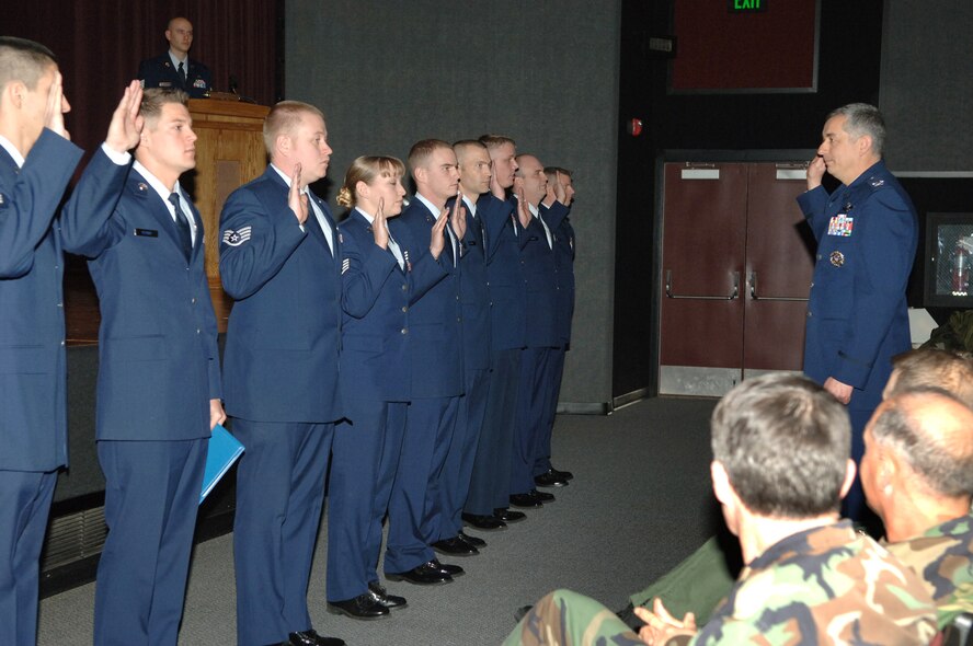 FAIRCHILD AIR FORCE BASE, Wash. – Col. Roger Watkins, 92nd Air Refueling Wing commander, swears in promotees recognized at the Wing Promotion Ceremony Dec. 28 at the base theater. (U.S. Air Force photo / Airman 1st Class Jocelyn Ford)