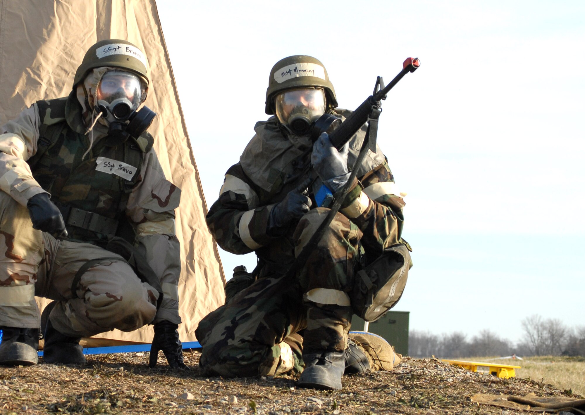 Master Sgt. Hugh Manning and Staff Sgt. Michael Bravo perform door guard duties and protect their tent during Exercise Haunted House Battle Ax Jan. 7 at Dover Air Force Base, Del. Defensive measures was one of the many skills practiced during the exercise. Sergeants Manning and Bravo are assigned to the 436th Aerial Port Squadron. (U.S. Air Force photo/Tech. Sgt. Kevin Wallace) 
