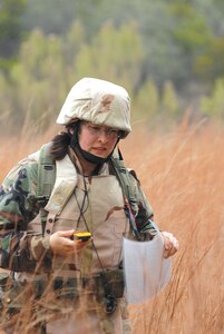 Maj. Victoria Nemmers from Langley Air Force Base, Va., uses a global positioning system to find designated points during the land navigation portion of the Common Battlefield Airman Training Bridge course at Camp Bullis, Texas, Dec. 19. Students use maps and compasses to find their way to a designated point and then use a GPS to find their way back. (U.S. Air Force photo by Steve White)