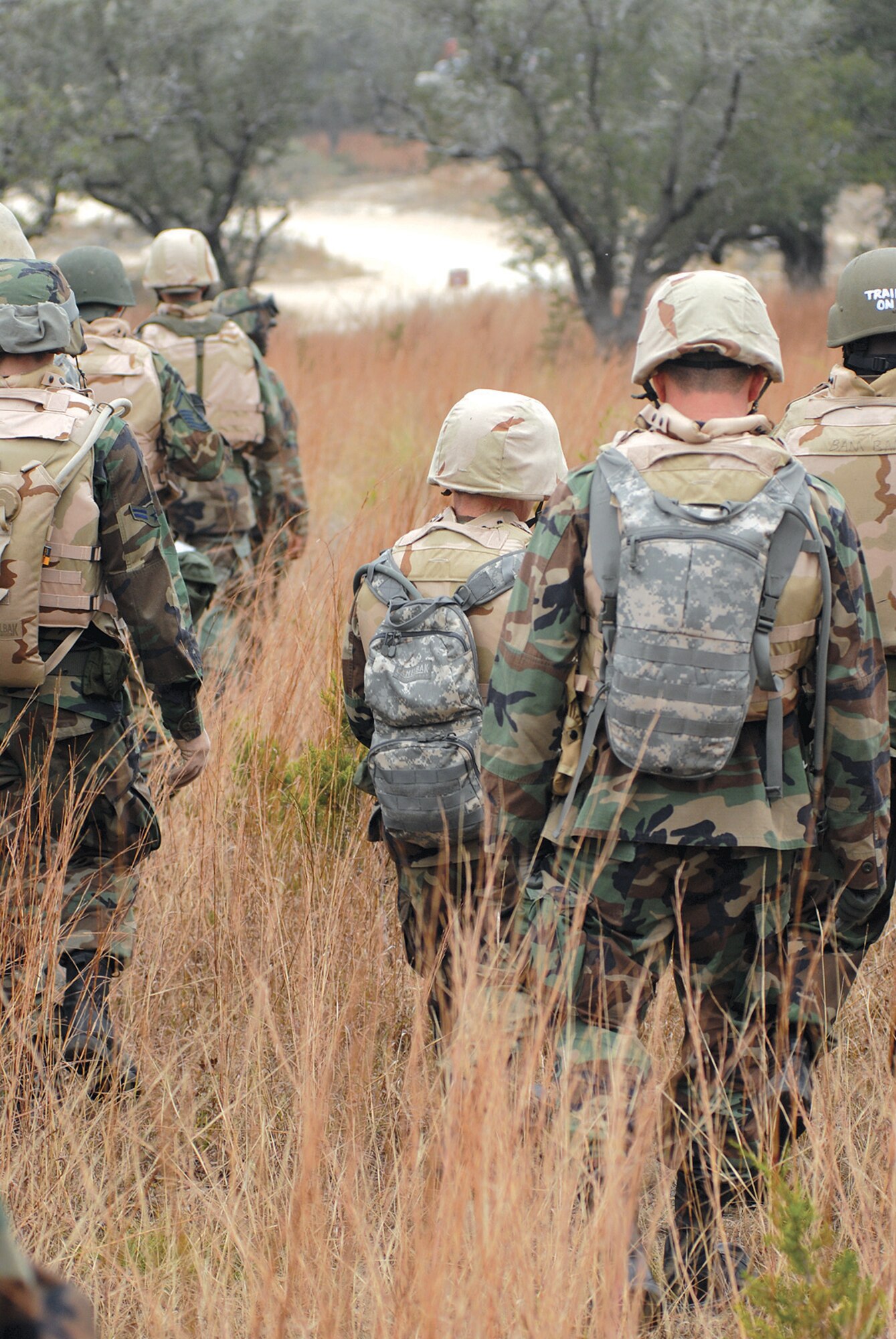 Common Battlefield Airman Training Bridge students walk back to Camp Anderson Peters after completing their land navigation training. Students broke into squads and practiced finding designated points using maps and compasses and global positioning systems. (U.S. Air Force photo by Steve White)