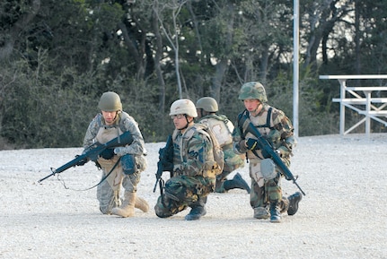 Common Battlefield Airman Training Bridge students Lt. Col. Bradley Burhite (left), from Wright Patterson Air Force Base, Ohio, Chief Master Sgt. Richard Catahay (center), from Scott AFB, Ill., and Senior Airman Steven Bruce, from Peterson AFB, Colo., form back up after practicing a danger crossing Dec. 20. The squad was taught team and individual movements and reacting to fire in the classroom and given time to practically apply their skills before a final field training exercise. (U.S. Air Force photo by Steve White)