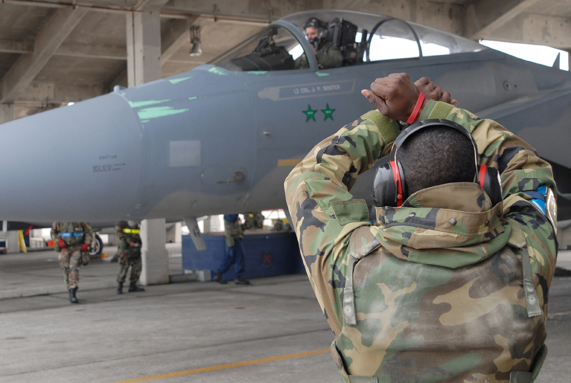 Airman 1st Class Lewis McNeal, 18th Aircraft Maintenance Squadron, marshals an F-15C piloted by Capt. Mike Jones, 44th Fighter Squadron, during Local Operational Readiness Exercise Beverly High 08-3. Kadena’s F-15s  have been grounded since November but 65 percent of the fleet has been cleared to resume flight operations. (U.S. Air Force photo/Tech. Sgt. Dave DeRemer)
