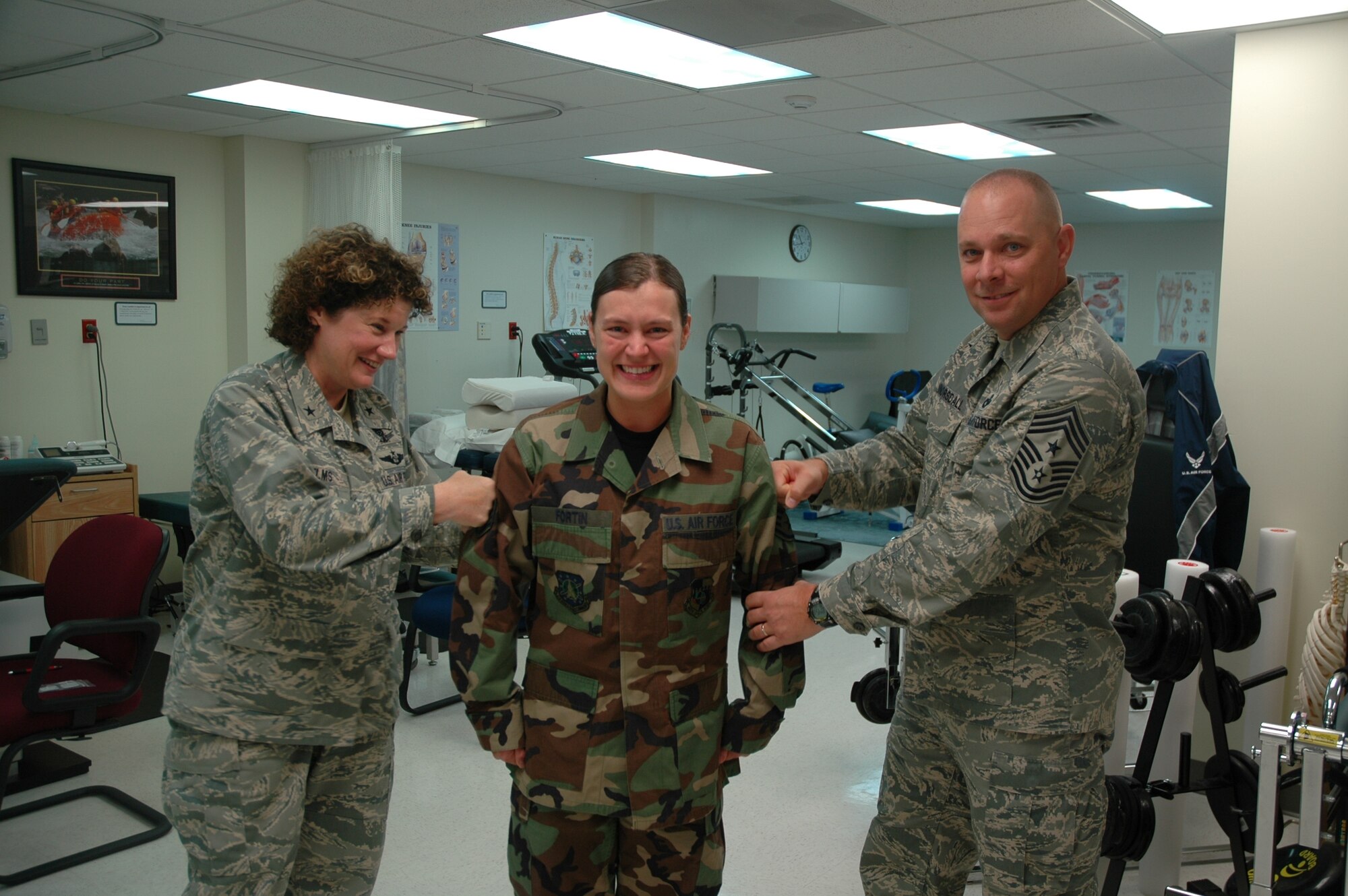 45th Space Wing Commander Brig. Gen. Susan Helms and Command Chief Master Sgt. Dennis Vannorsdall pin on Staff Sgt. Josee Fortin’s new rank at the Patrick AFB Clinic. On Sunday she was a Senior Airman, but on Monday she was immediately promoted to Staff Sergeant under the Air Force’s Stripes for Exceptional Performers (STEP) program. “She has been outstanding since her first assignment,” said Lt. Col. Judith Hughes, deputy commander of the 45th Medical Group. “Her work is always of the highest caliber. Our Physical Therapy Flight is blessed to have her working on our team.” (U.S. Air Force photo by Airman David Dobrydney)