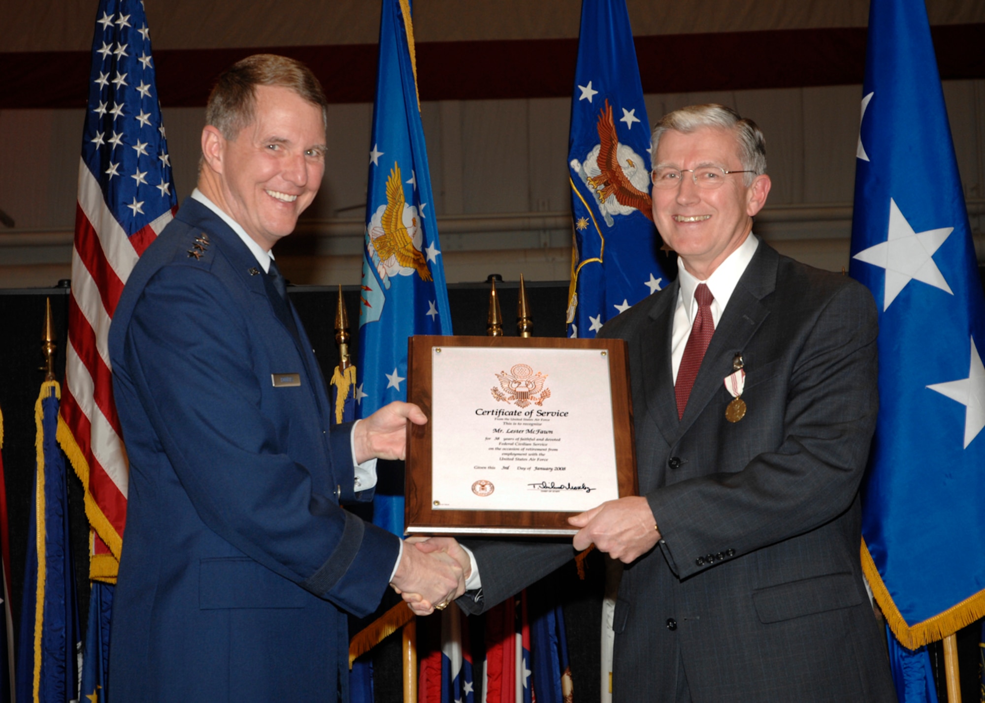 Lt. Gen. Ted Bowlds, left, presents Mr. Les McFawn with his retirement certificate Wednesday at the National Museum of the U.S. Air Force.  Mr. McFawn, the AFRL Executive Director, retired with 38 years of government service.  (AF photo by Al Bright)

