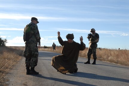 Maj. Roy Thrailkill (right), from the Air Education and Training Command Headquarters at Randolph AFB, challenges Common Battlefield Airman Training Bridge instructor Staff Sgt. Joe Pearcy, Combat Controller, while CBAT-B instructor Tech. Sgt. Christopher Dunstone, Combat Weather Specialist, acts as an interpreter. CBAT-B course cadre consist of Battlefield Airmen of all specialties, including Security Forces, Transportation, Explosive Ordnance Disposal, Survival, Combat Weather, Tactical Air Control, Combat Control and Pararescue. (U.S. Air Force photo by SSgt. Beth Del Vecchio)  