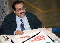 Santos Madrigal Jr., 37th Civil Engineer Squadron, enjoys his retirement ceremony Dec. 13 at the Lackland Recycling Center. The 77-year-old spent more than 42 years as a civilian civil engineer at Lackland, helping build the base into the largest Air Force training base in the U.S. (USAF photo by Robbin Cresswell) 