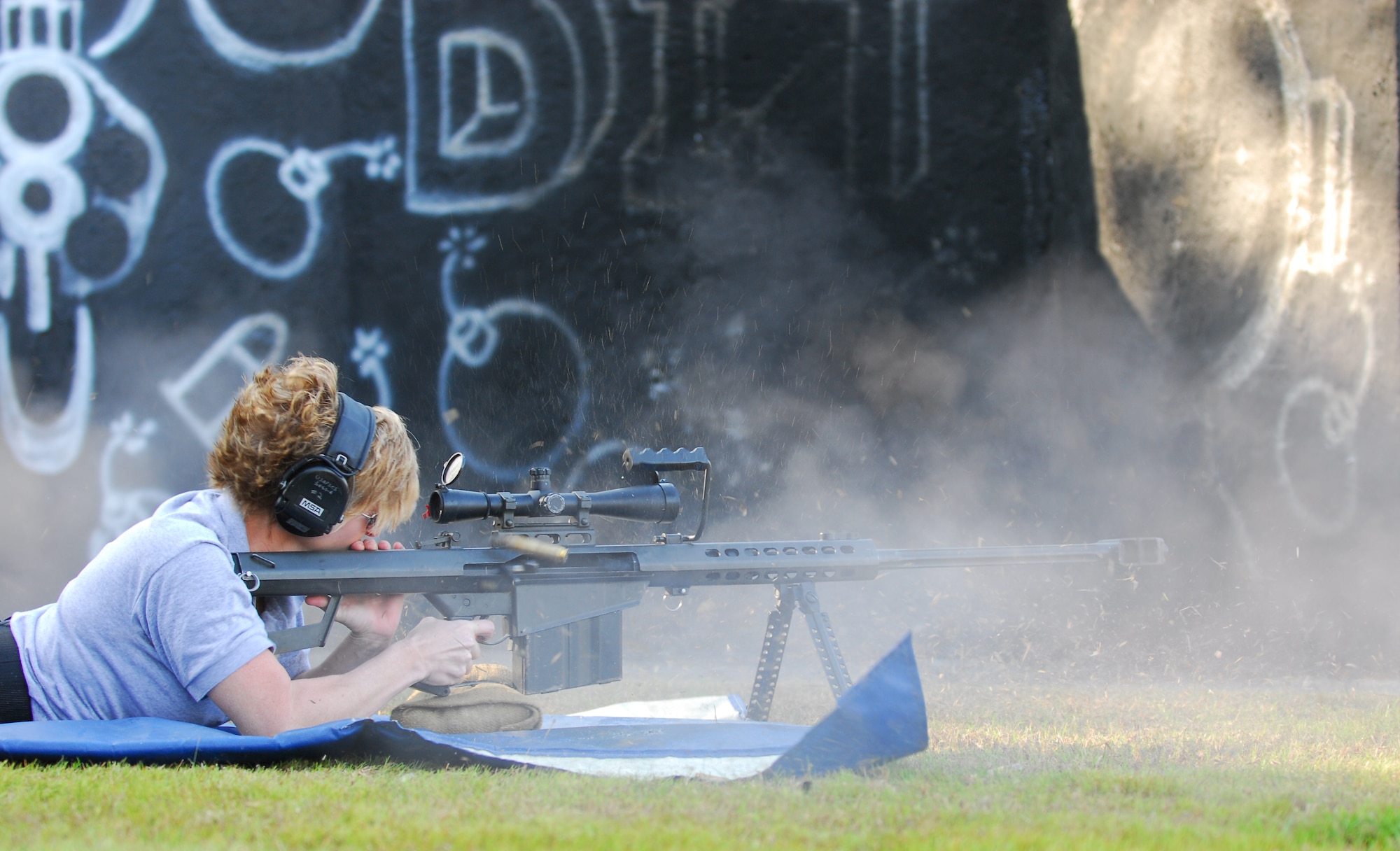Master Sgt. Tanya Breed, U.S. Air Force Special Operations School, fires a Barrett .50-caliber rifle at a target 300 meters downrange during a weapons capabilites demonstration Jan. 9 on the Dynamics of International Terrorism range at Hurlburt Field. Sergeant Breed shows the crowd capabilites of sniper fire at various targets. The demonstration shows students from the DIT course the capabilities of weapons primarily used by terrorist groups. Students from all branches of the U.S. military participate in the course. (U.S. Air Force photo/Airman 1st Class Jason Epley)