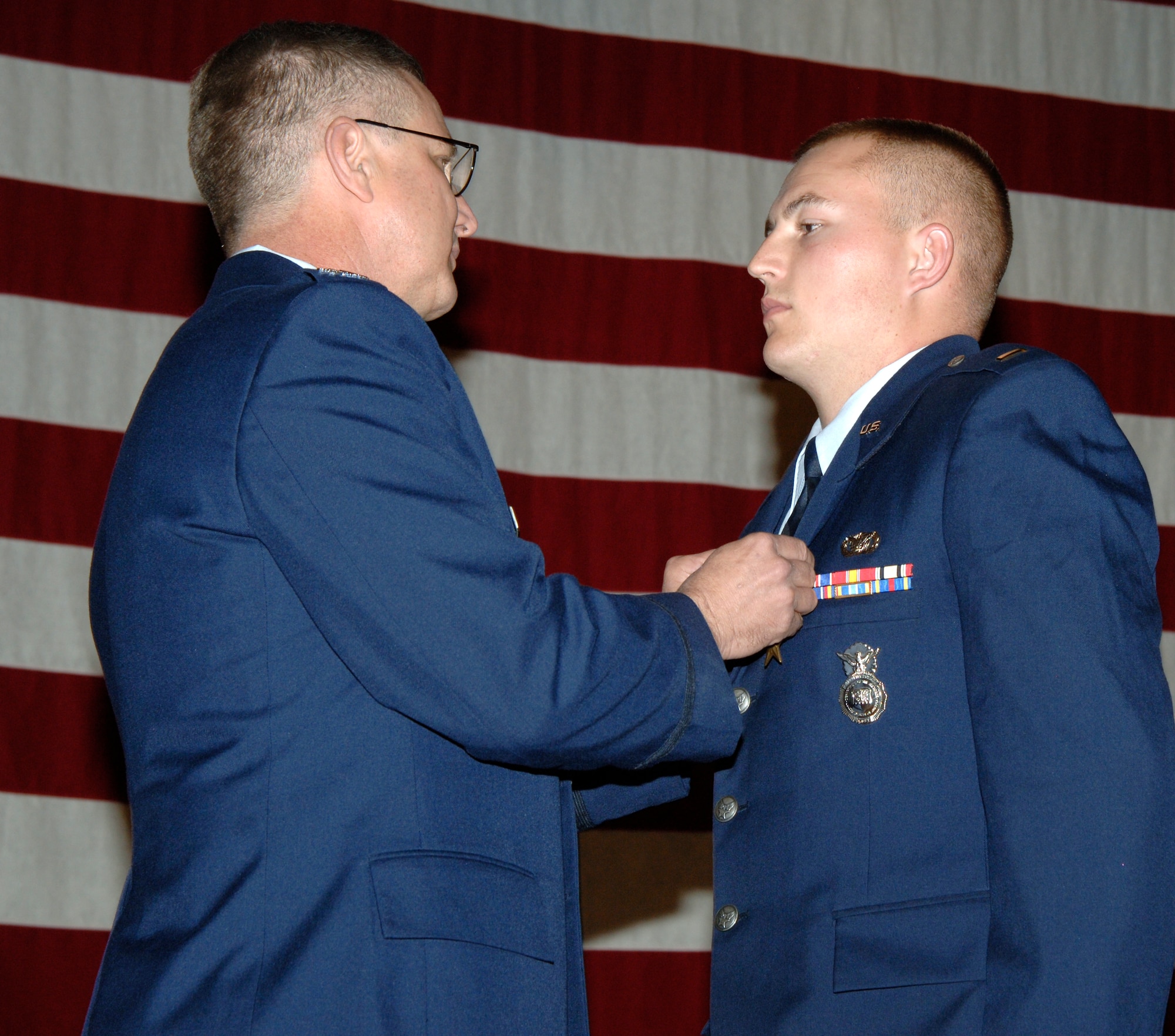 Col. Donald Halpin, 22nd Air Refueling Wing commander, pins a Bronze Star medal to 2nd Lt. Jack McGonegal, 22nd Security Forces Squadron during a ceremony Nov. 29. A bronze star medal is awarded to a person who distinguishes himself or herself by heroic or meritorious achievement, not involving aerial flight, while engaging in an action against an enemy of the United States. (Photo by Tech. Sgt. Chyrece Campbell) 