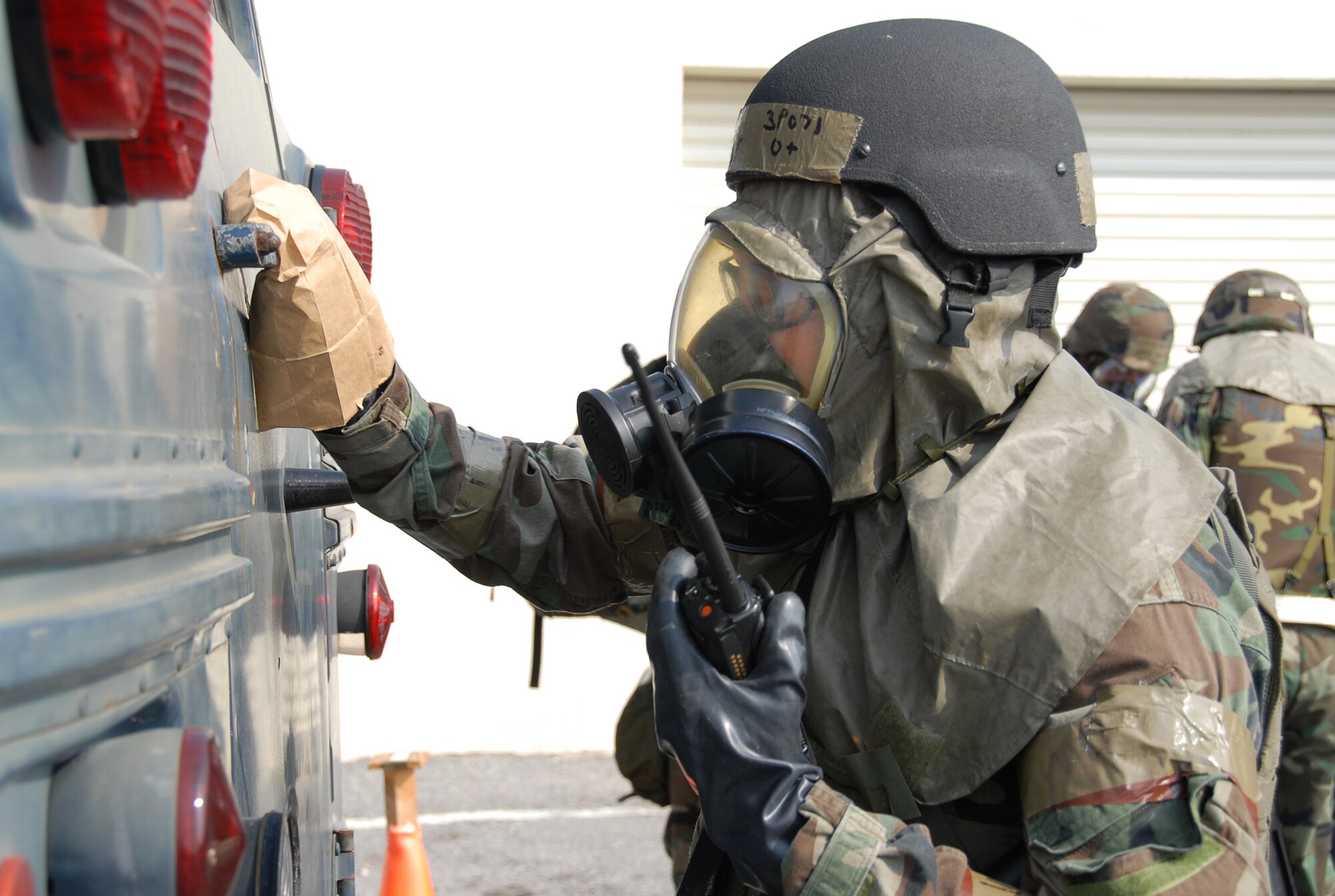 Tech. Sgt. Robert Roller decontaminates a bus prior to evacuation to a relocation point following a simulated missile attack during Local Operational Readiness Exercise Beverly High 08-3 at Kadena Air Base, Japan, Jan. 10, 2007. The 18th Wing conducted the exercise from Jan. 7 to 11 to test the wing's ability to respond in contingency situations.   (U.S. Air Force photo/Tech Sgt. Anthony Iusi)
