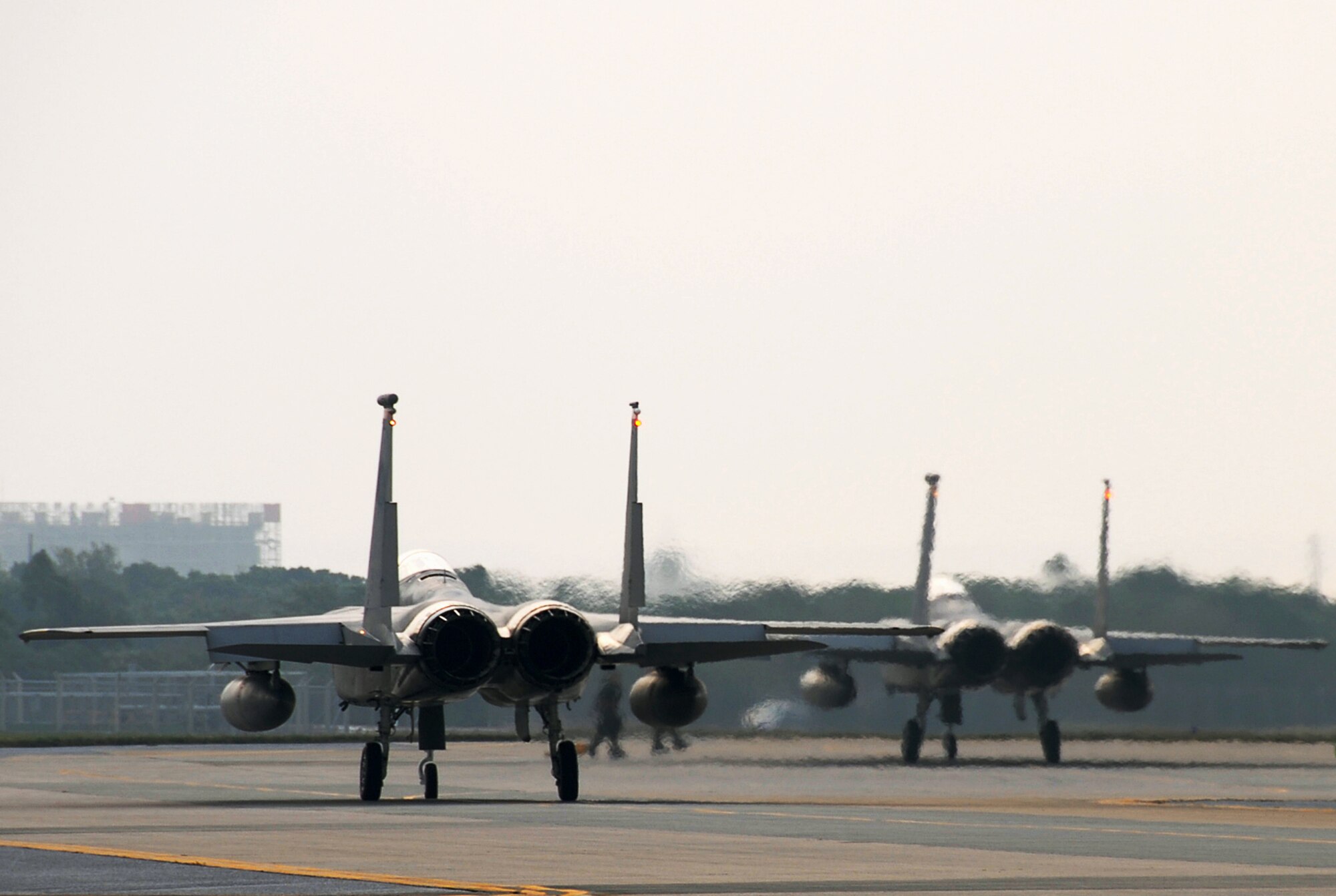 Two Kadena F-15C Eagles prepare for pre-flight inspections during Local Operational Readiness Exercise Beverly High 08-3 at Kadena Air Base, Japan, Jan. 10, 2007. The 18th Wing conducted the exercise from Jan. 7 to 11 to test the wing's ability to respond in contingency situations. (U.S. Air Force photo/Tech Sgt. Anthony Iusi) 