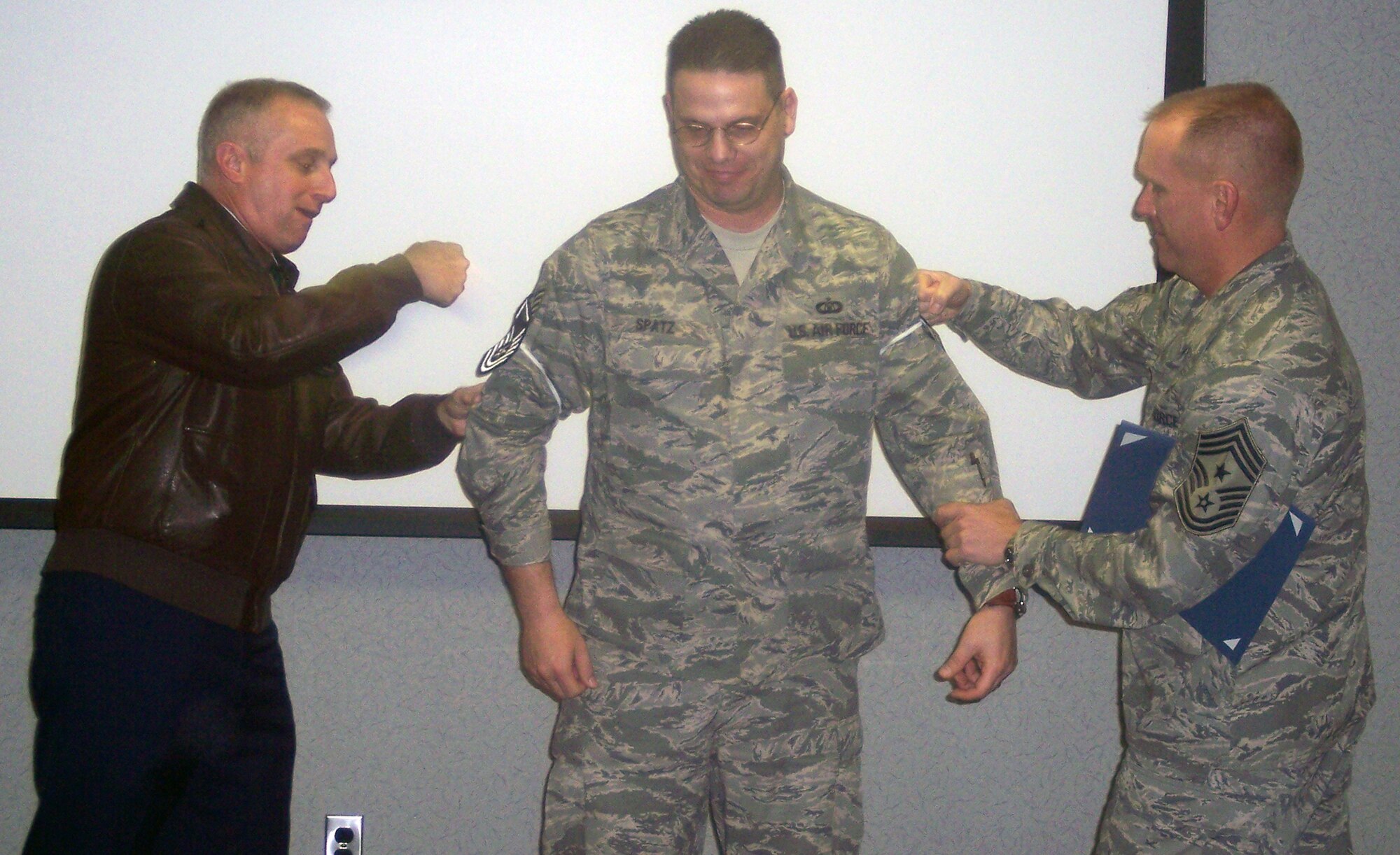 WHITEMAN AIR FORCE BASE, Mo. - Tech. Sgt. Carl Spatz, 509th Operations Support Squadron, gets his new master sergeant stripes put on by Brig. Gen. Garrett Harencak, 509th Bomb Wing commander, and Chief Master Sgt. Brian Hornback, 509th Bomb Wing command chief master sergeant during his Stripes for Exceptional Performance promotion Jan. 8. STEP promotions are reserved for staff sergeants to master sergeants, and presented selectees who have had approved recommendations by their commanders and meet the following criteria: candidates have performed outstanding in their duty section, are involved in off-duty activity in local communities, worked on self-improvement, and have been recognized for their job or non-duty performance. (Photo printed with permission of Chief Master Sgt. Brian Hornback)

