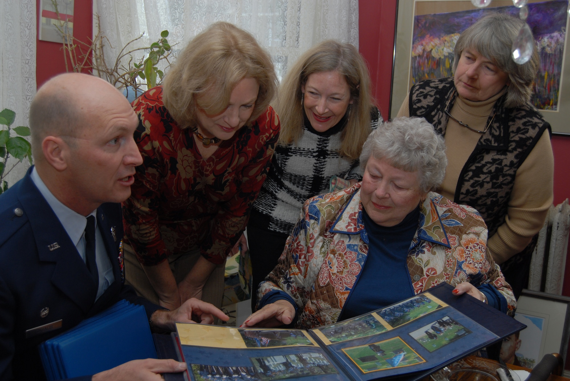 Col. Timothy Zadalis, 43rd Airlift Wing Commander, shares pictures and stories Jan. 4 with the family of the late Lt. Col. Jay Zeamer, Jr., 43rd Bombardment Group (Heavy) in her home in Winchester, Mass.  Colonel Zadalis presented certificates of appreciation to Colonel Zeamer's wife, Barbara, and daughters Jayne, Sandra and Jacque as well as Susan and Marcia (not pictured). Mrs. Zeamer loaned all of her husbands medals, including the Medal of Honor, Purple Heart, Air Medals and Distinguished Flying Cross to the 43rd AW. The medals will be displayed along with pictures of Colonel Zeamer in the foyer of the Wing Headquarters building. (U.S. Air Force Photo by Staff Sgt. Jon LaDue)
