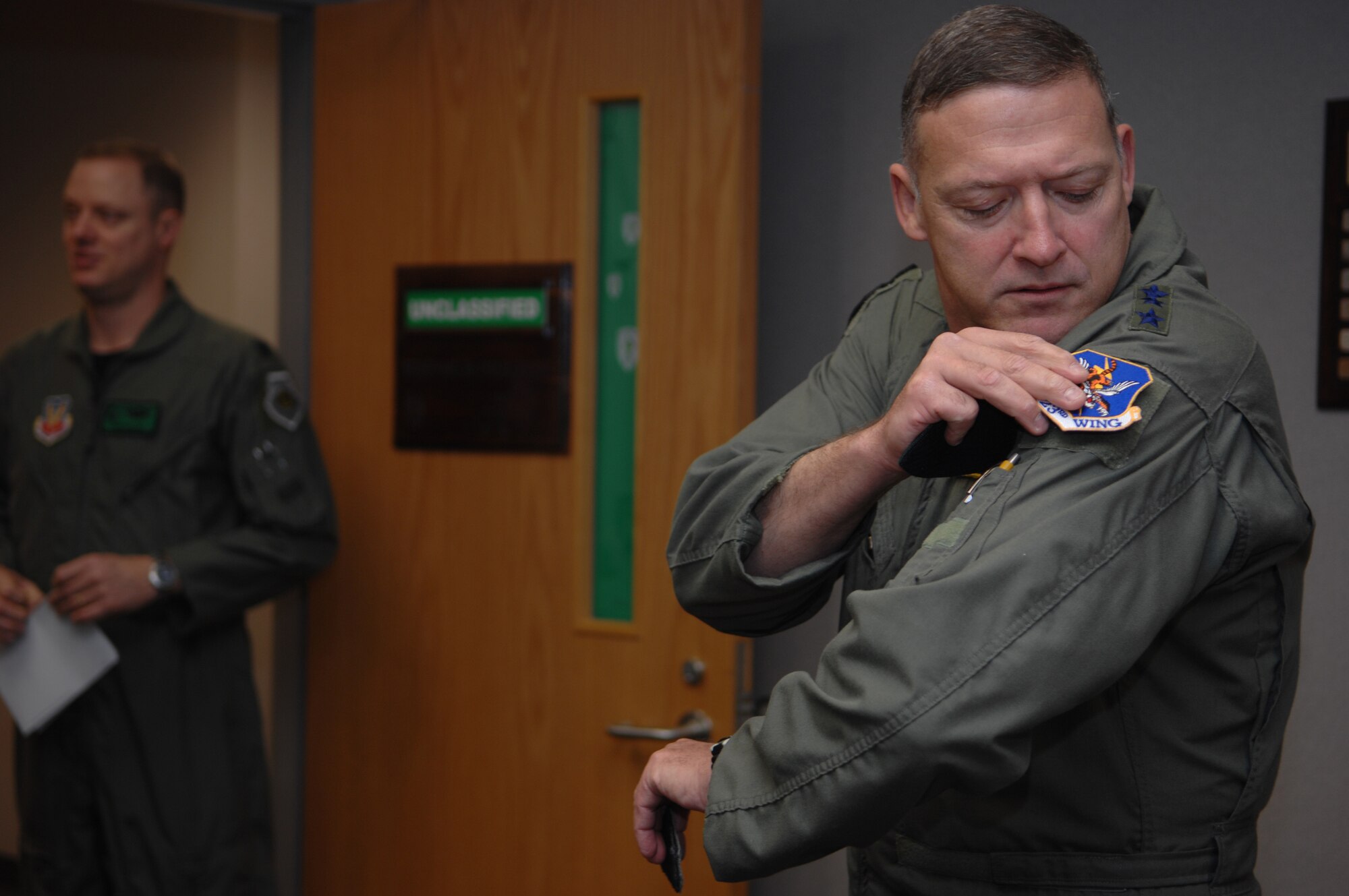 MOODY AIR FORCE BASE, Ga. – Lt. Gen. Gary North, 9th Air Force commander, places a 23rd Wing patch on his uniform at the 41st Rescue Squadron Jan 7.  General North visited the 23rd WG to get a first-hand view of the base's mission. (U.S. Air Force photo by Senior Airman Angelita Lawrence)