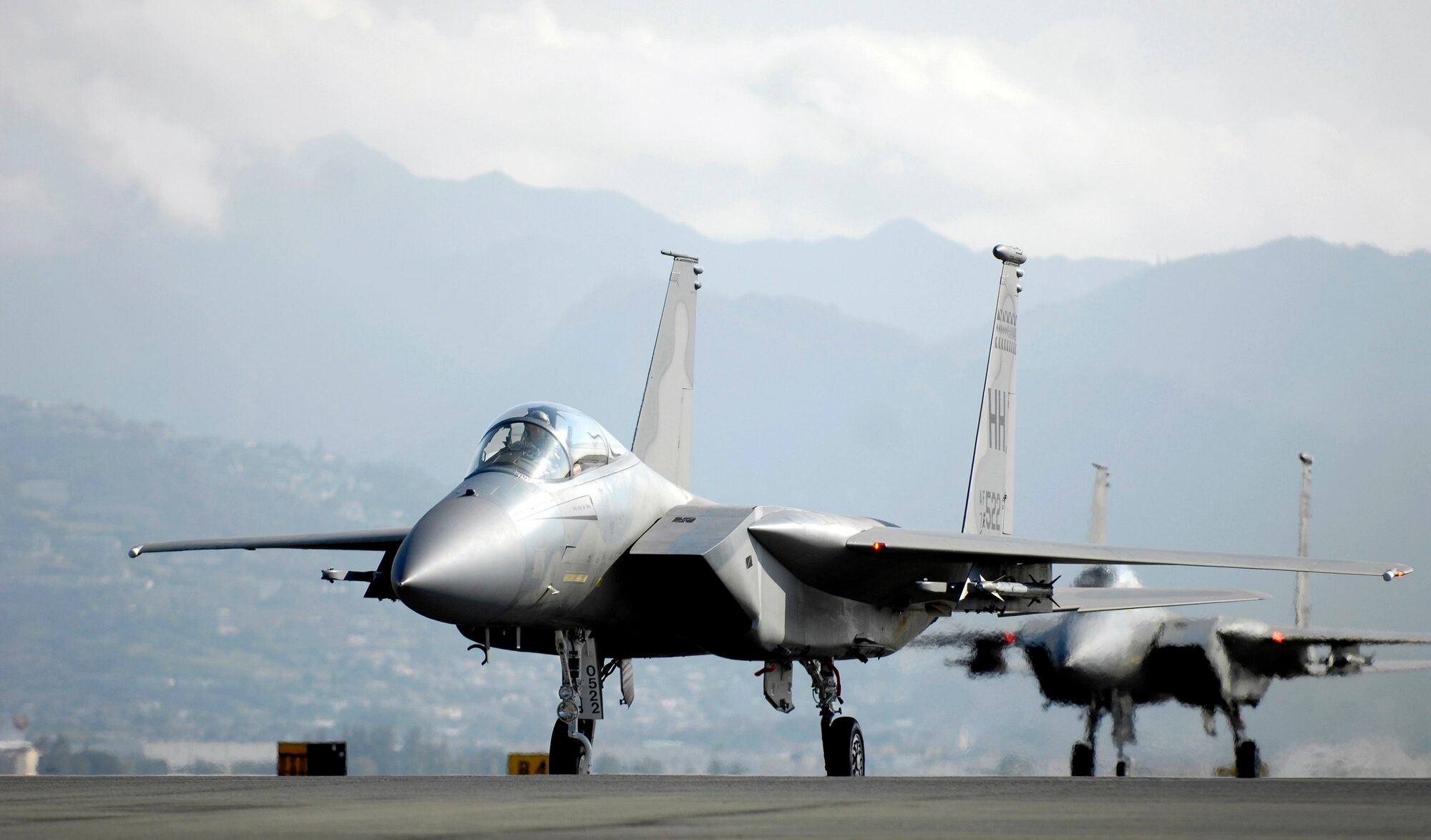 F-15 Eagles taxi on the flightline after flying a mission Jan. 9 at Hickam Air Force Base, Hawaii. The F-15s, from the 199th Fighter Squadron of the Hawaii Air National Guard, have not flown since Air Force officials grounded the F-15 fleet Nov. 3, 2007. Air Combat Command officials cleared a portion of its F-15 A through D models to begin flying today. (U.S. Air Force photo/Tech. Sgt. Shane A. Cuomo) 
