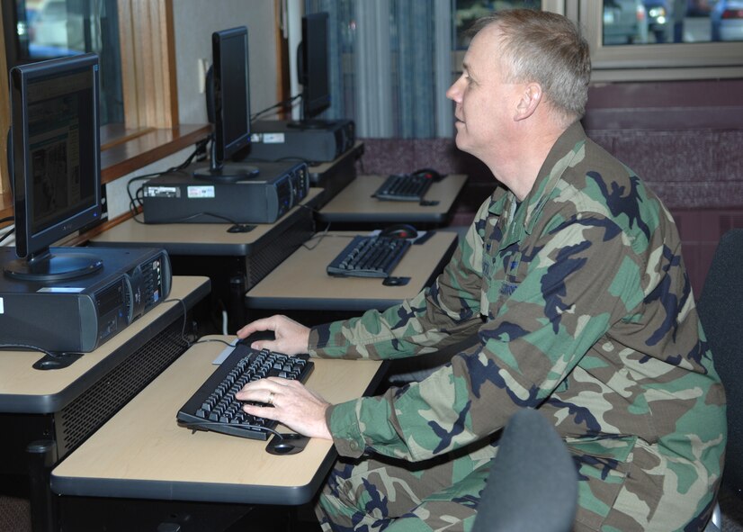 MINOT AIR FORCE BASE, N.D. -- Col. Joel Westa, 5th Bomb Wing commander, takes advantage of the new cyber cafe at the Dakota Inn Dining Facility here Jan. 9. Colonel Westa was on hand to cut a ribbon to officially open the cafe for business. (U.S. Air Force photo by Senior Airman Stacey Moless)