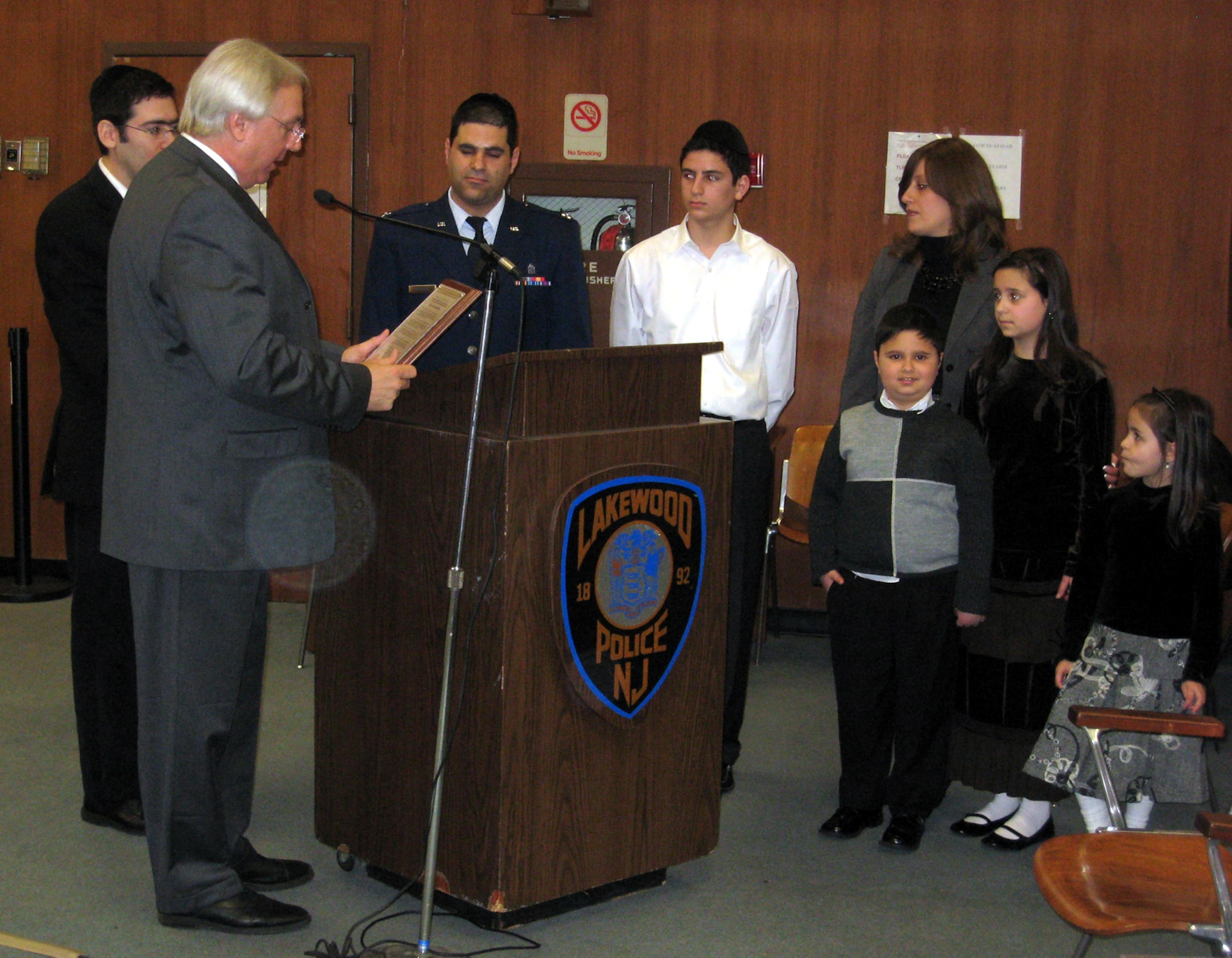Center, Chaplain Rabbi (Capt.) Raphael Berdugo, 305th Air Mobility Wing, accepts a proclamation Jan. 1, signed by newly-appointed Lakewood Township Mayor Coles, honoring him for his service to our country and his upcoming deployment. The township invited Chaplain Berdugo to give the invocation at its first meeting of the year. The chaplain’s family and friends also attended the ceremony. (U.S. Air Force courtesy photo)       