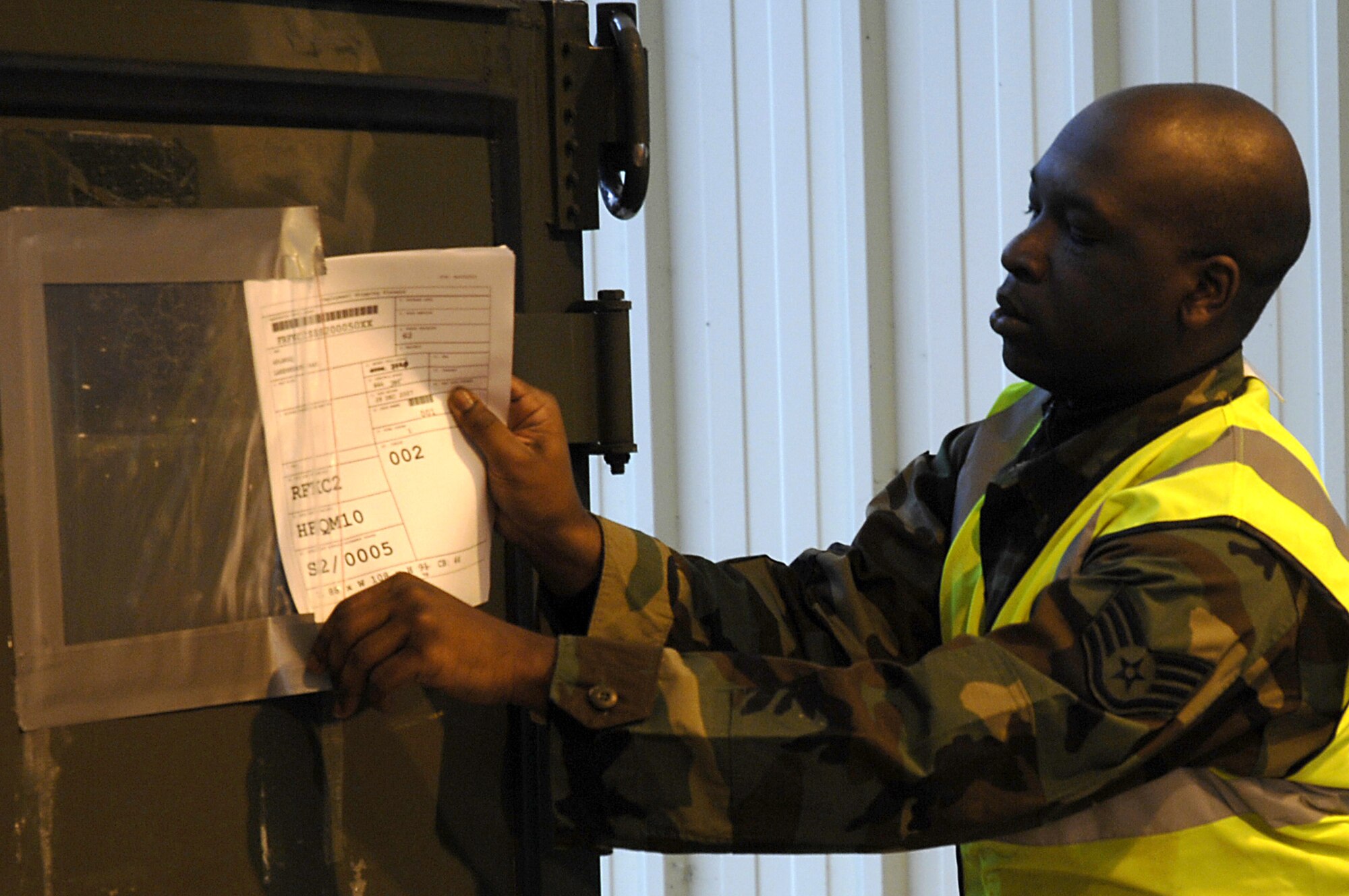 Staff Sgt. Trevor Eaddy, 48th Logisitics Readiness Squadron Transportation Management Office craftsman, replaces a transportation placard after making corrections Jan. 4 at RAF Lakenheath, England. 48th LRS Airmen are inspecting equipment in preparation for RAF Lakenheath’s participation in a Red Flag exercise at Nellis Air Force Base, Nevada. (U.S. Air Force photo by Senior Airman Brian Ellis)
