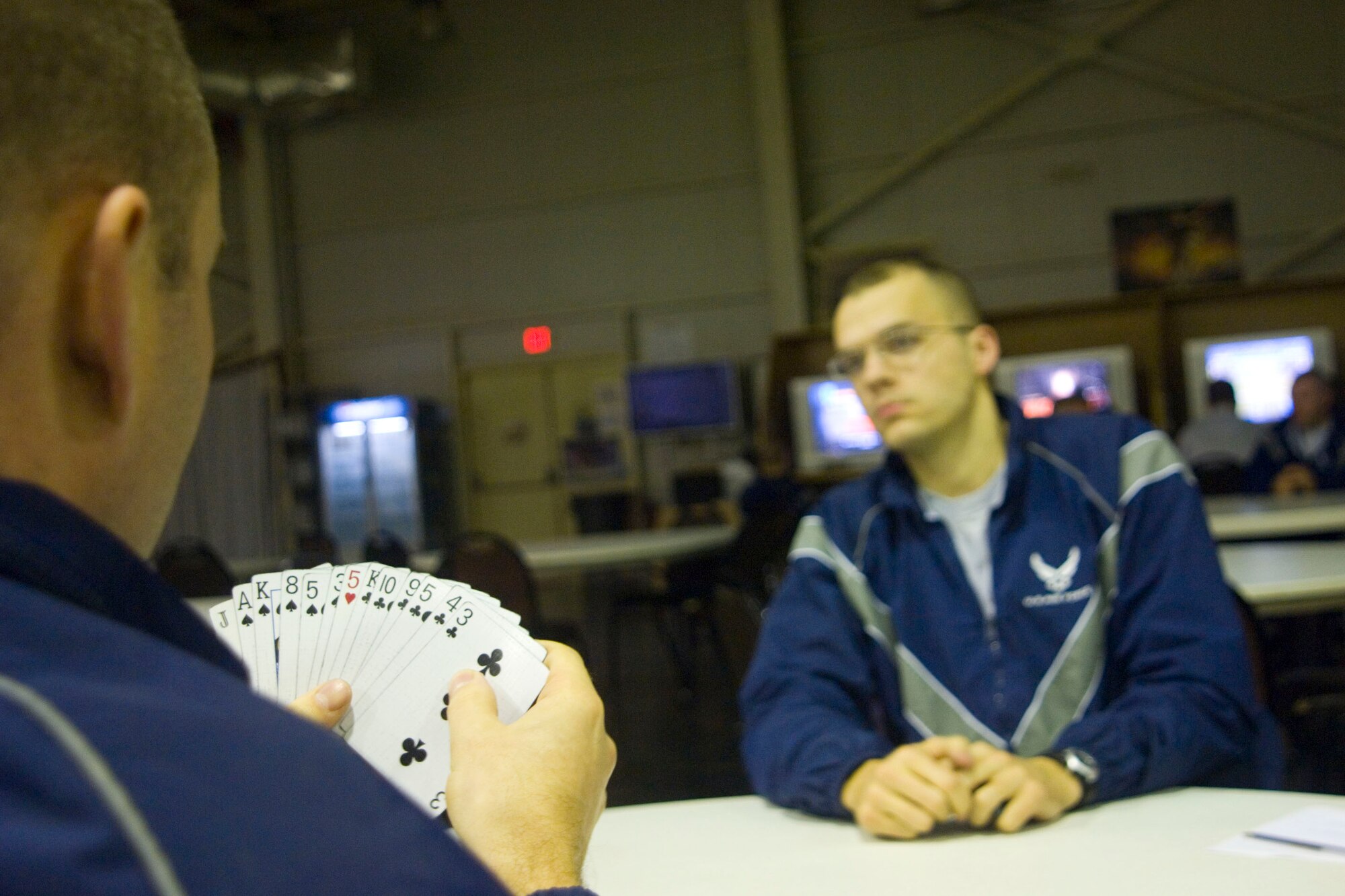BALAD AIR BASE, Iraq -- Airman 1st Class Nathan Crandall, right, 332nd Expeditionary Maintenance Squadron, waits patiently as his spades partner, Tech. Sgt. Jamie Schuster, 332nd EMXS, contemplates his next move at the Red Tail Recreation Center here, Jan. 9. Airman Crandall and Sergeant Schuster are deployed from Spangdahlem Air Base, Germany. (U.S. Air Force photo/Staff Sgt. Travis Edwards)