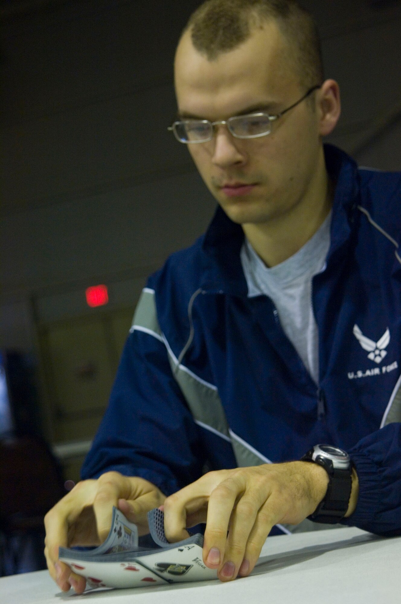 BALAD AIR BASE, Iraq -- Airman 1st Class Nathan Crandall, 332nd Expeditionary Maintenance Squadron, shuffles a deck of cards before dealing a hand of spades in the Red Tail Recreation Center here, Jan. 9. The recreation center is a place for deployed troops to hang out and unwind, as well as enjoy themed nights like karaoke, salsa and bingo. Airman Crandall is deployed from Spangdahlem Air Base, Germany. (U.S. Air Force photo/Staff Sgt. Travis Edwards) 