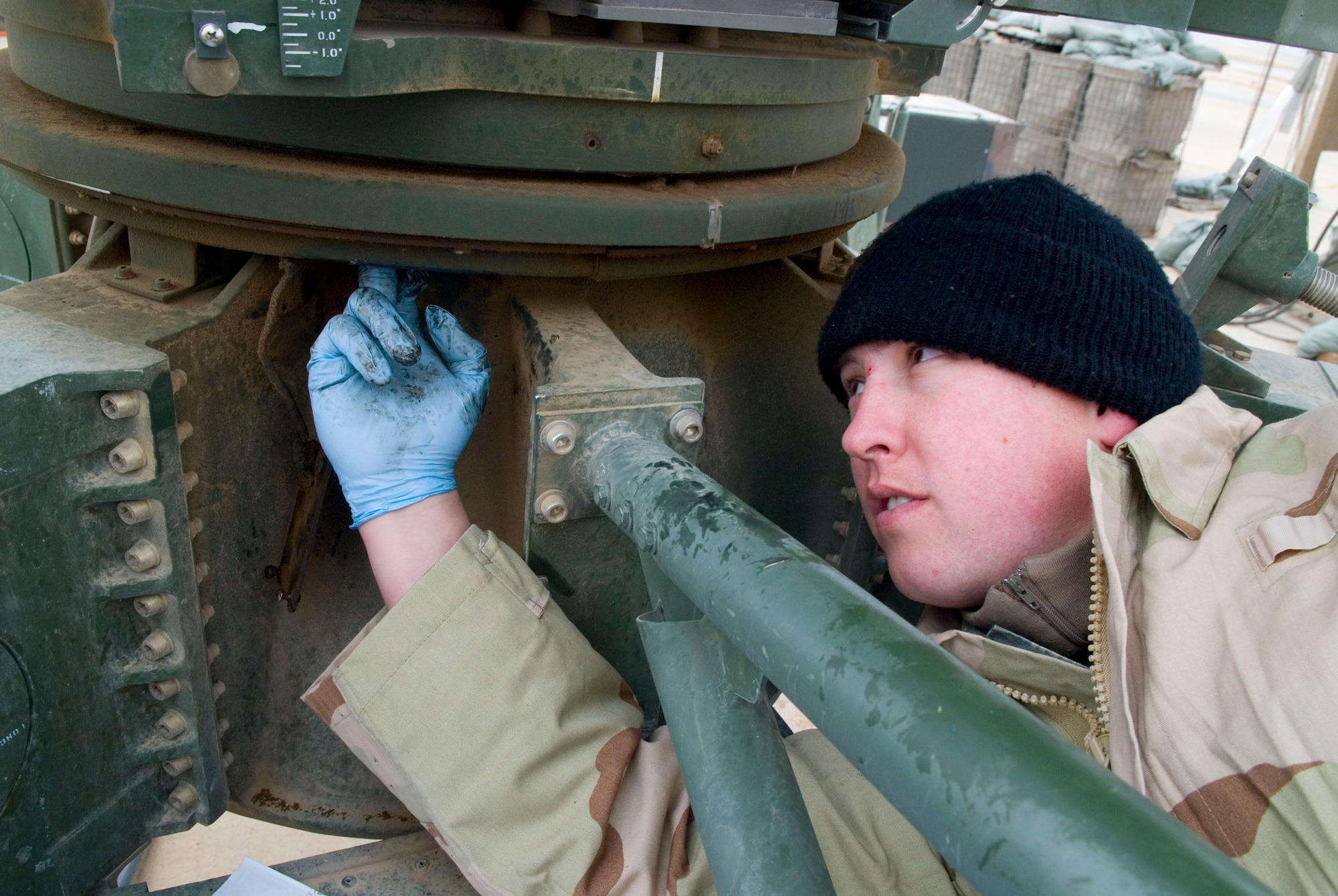 BALAD AIR BASE, Iraq -- Senior Airman Daniel Cody, a 727th Expeditionary Air Control Squadron ground radio maintainer, performs preventive maintenance on a radar antenna here, Jan. 10. The maintenance is done at least once a month to ensure the radar antenna functions properly. Airman Cody is deployed from Mountain Home Air Force Base, Idaho. (U.S. Air Force photo/Staff Sgt. Joshua Garcia)