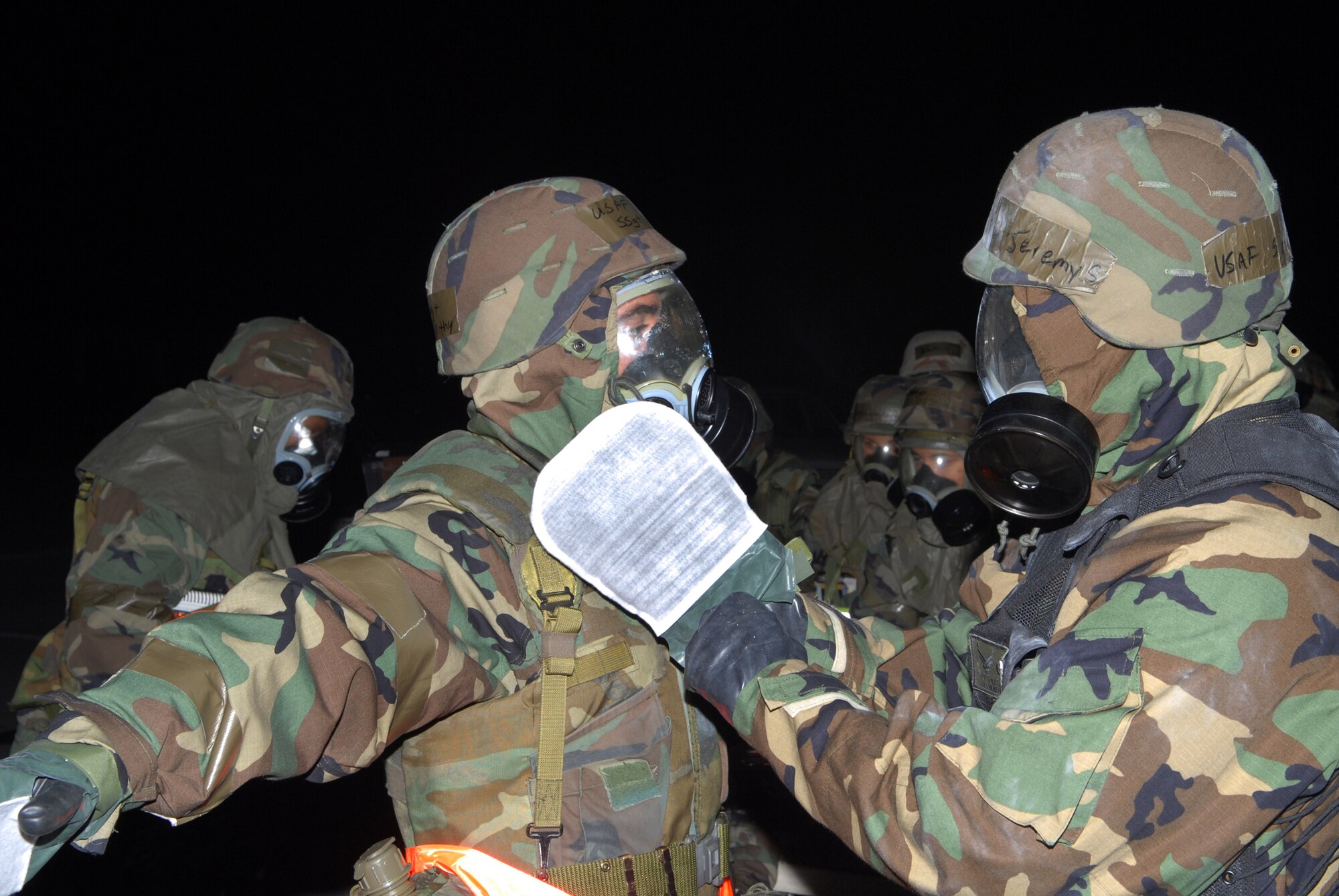 Staff Sgt. Eugene McCarthy, 718th Civil Engineer Squadron and Senior Airman Jeremy Visser, 18th Communications Squadron, process through a contamination control area, during Local Operational Readiness Exercise Beverly High 08-3 at Kadena Air Base, Japan, Jan. 10, 2007. The 18th Wing conducted the exercise from Jan. 7 to 11 to test Airmen's ability to respond in contingency situations. 
(U.S. Air Force photo/ Staff Sgt. Chrissy FitzGerald)
