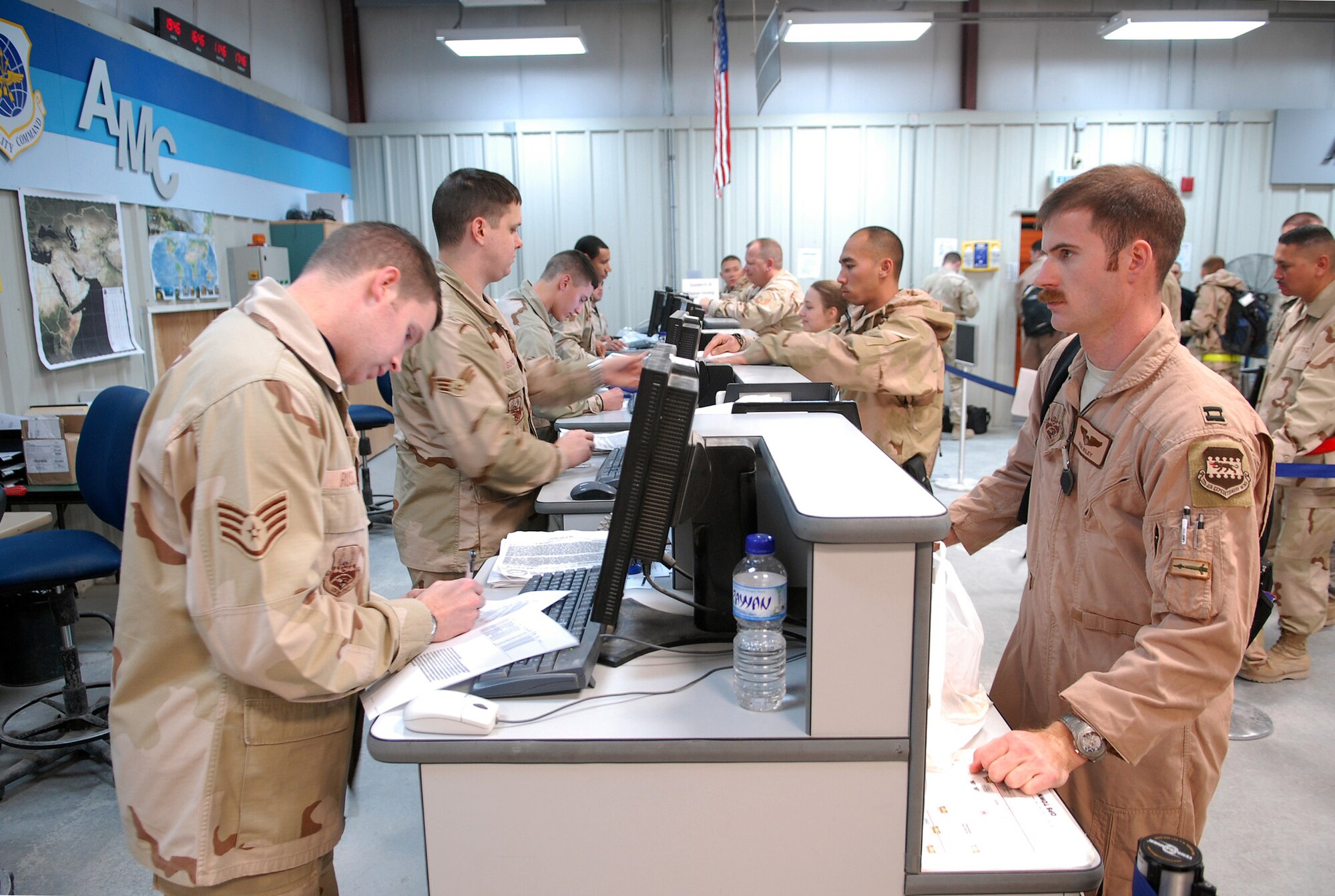 SOUTHWEST ASIA - Staff Sgt. Benjamin Russell, 8th Expeditionary Air Mobility Squadron, assists homeward bound Capt. Ryan Riley Jan. 7 at a Southwest Asia air base.  Captain Riley is headed back to Hill Air Force Base, Utah. (U. S. Air Force photo/Staff Sgt. Douglas Olsen)